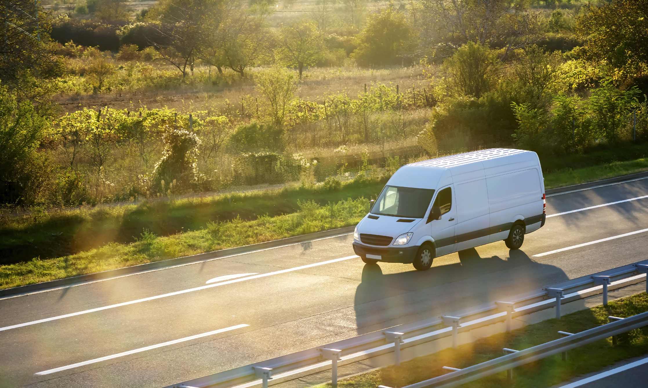 White van driving on the road