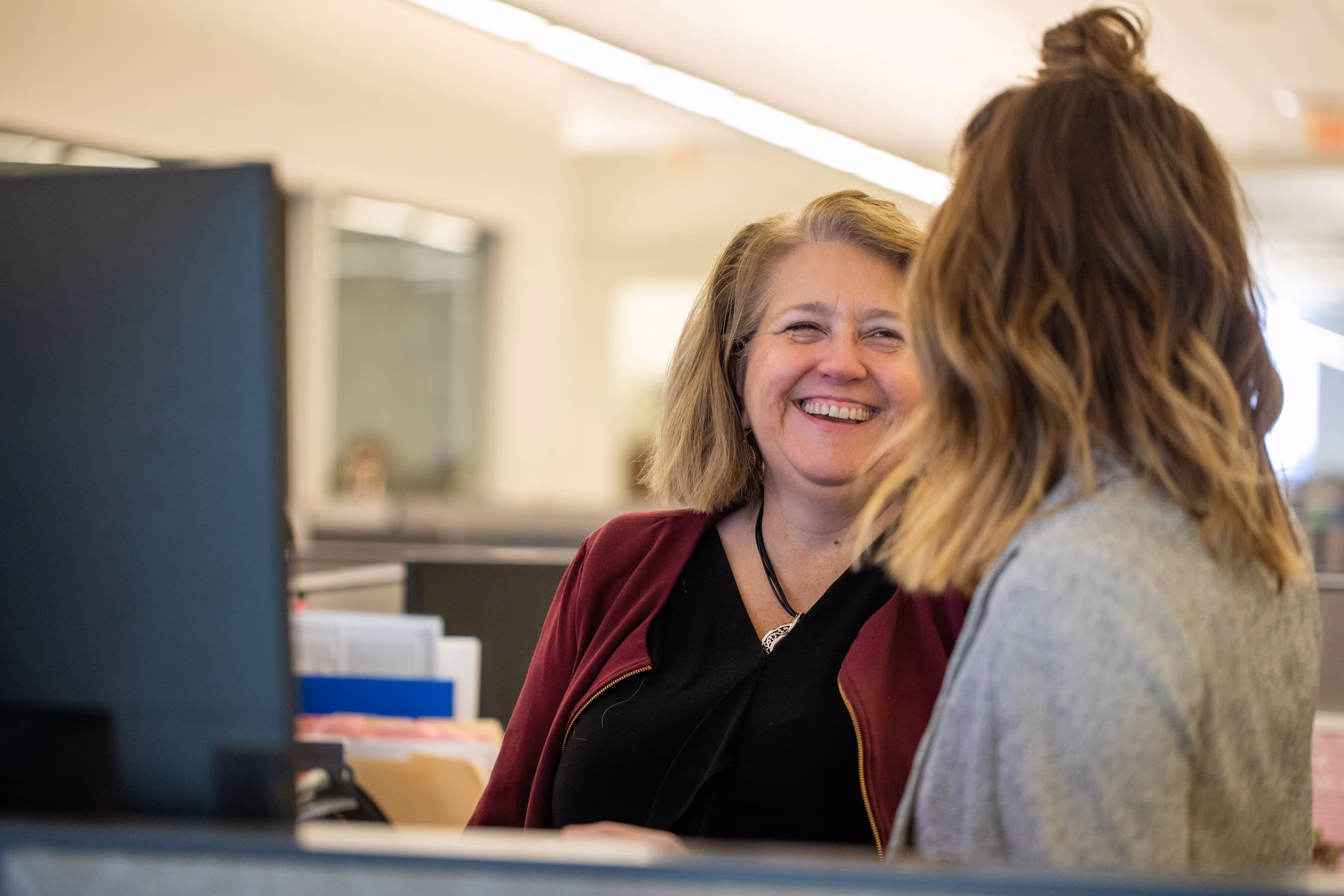 TrueNorth colleagues smiling at one another. 