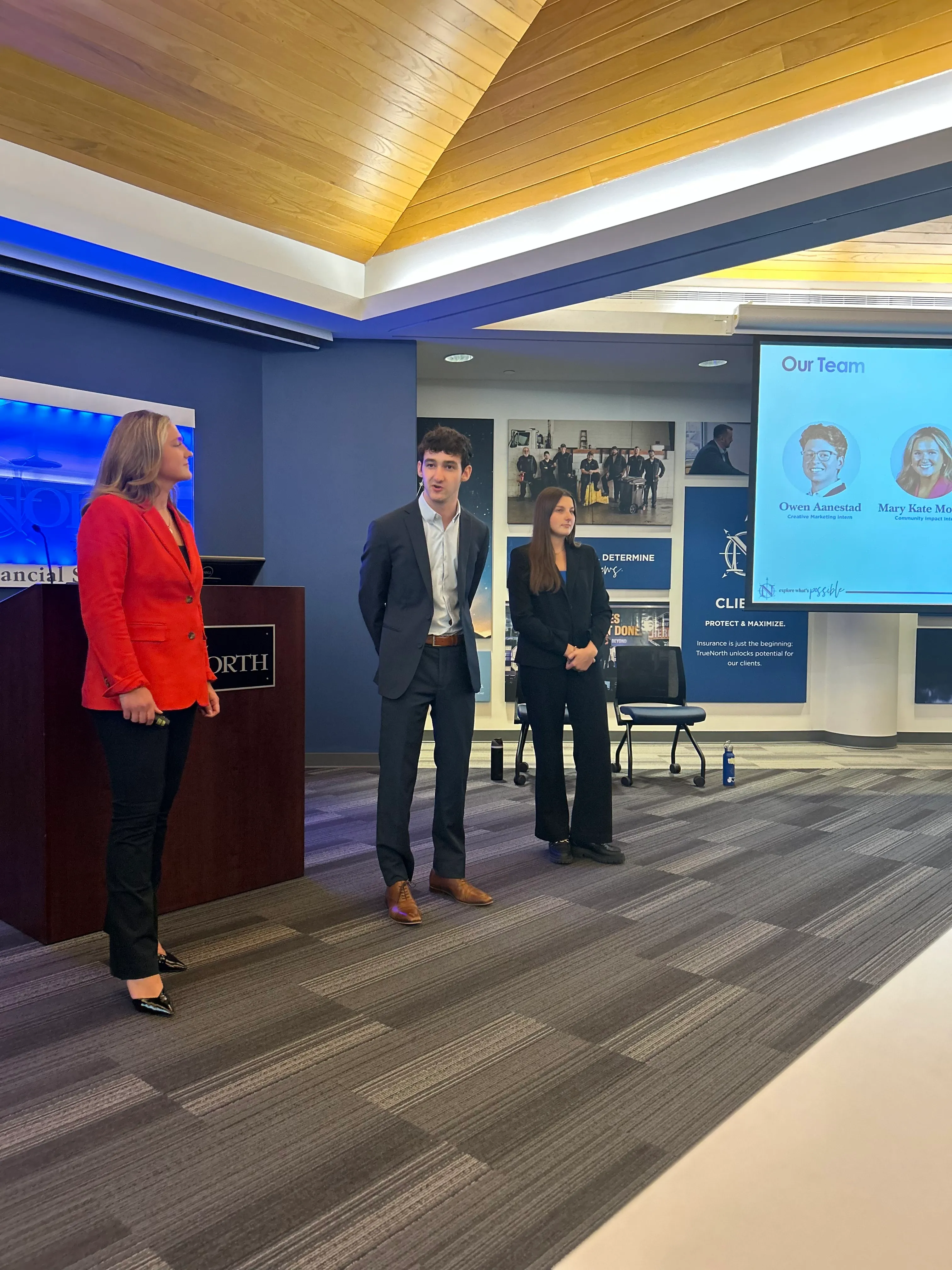 Group of TrueNorth interns presenting in front of a podium