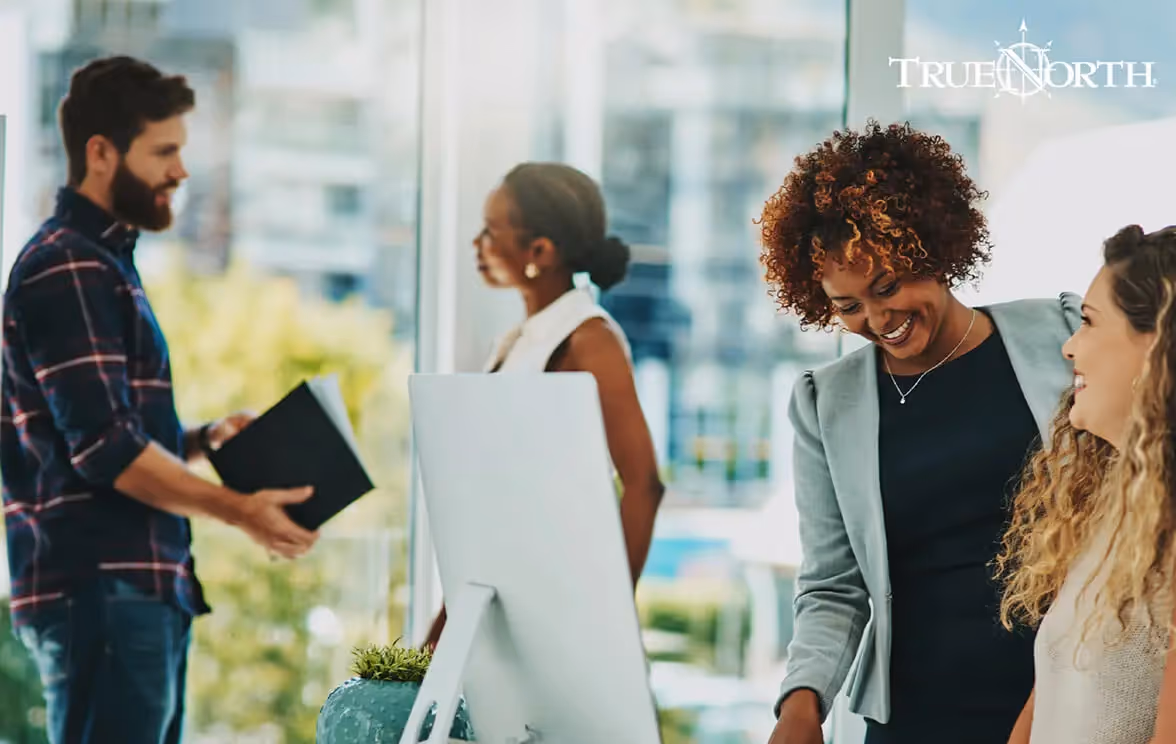 Photo of a group of people talking in an office
