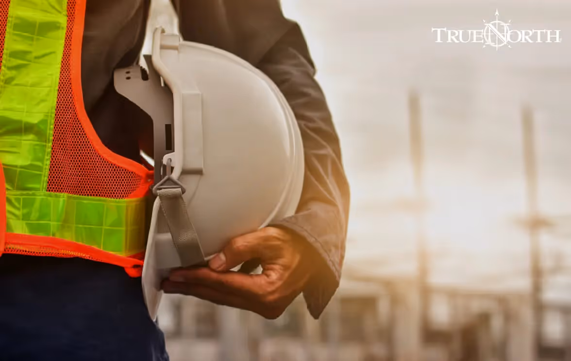 Photo of a worker holding his protection helmet