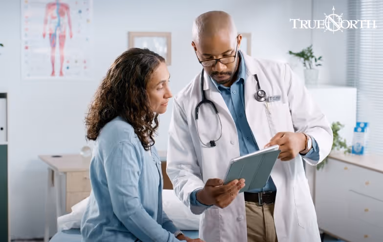 doctor talking to a patient holding clipboard