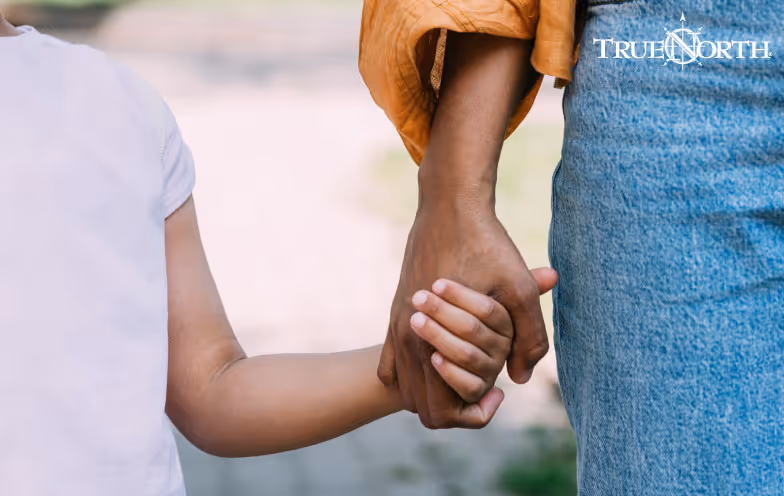 small child holding adult hand