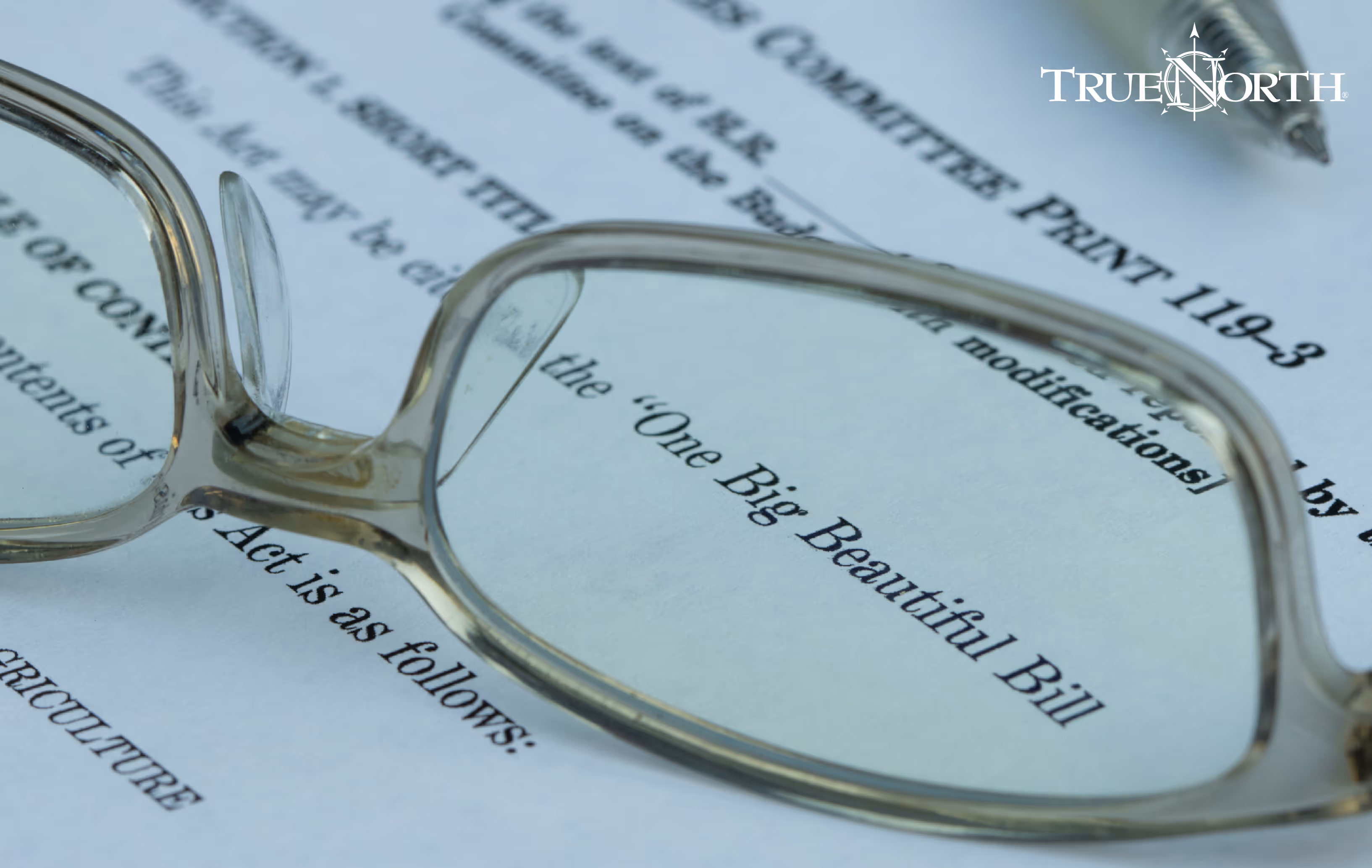 One Big Beautiful Bill document with glasses on top