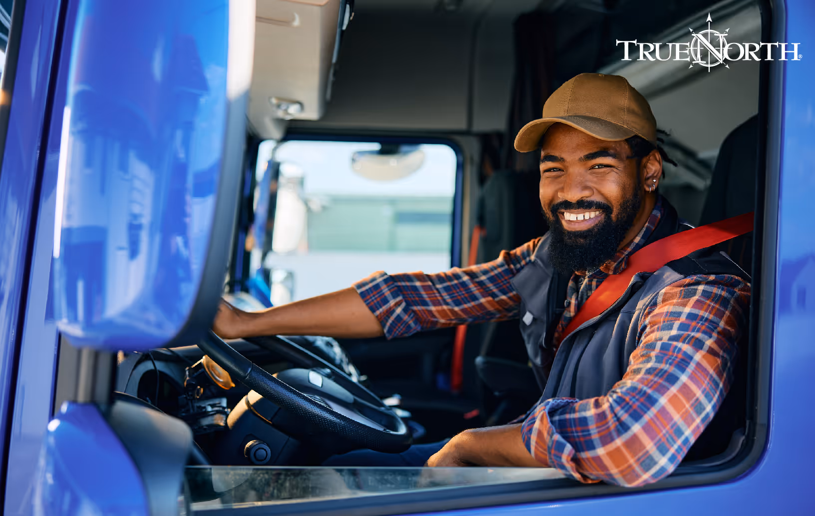 truck driver smiling from driver seat