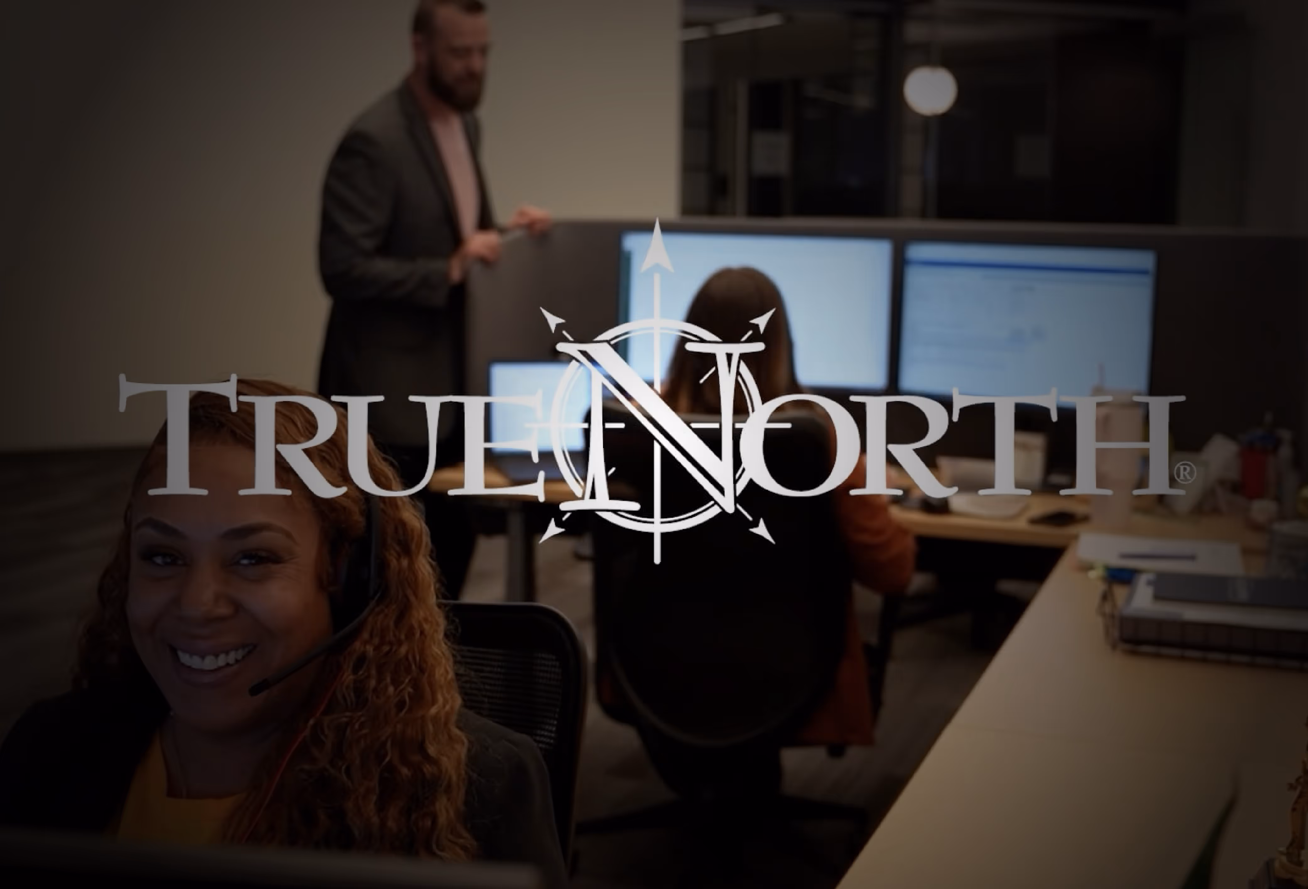 TrueNorth logo over employees in the office