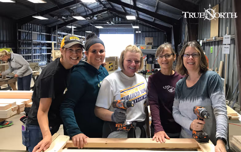 colleagues pose for photo in warehouse