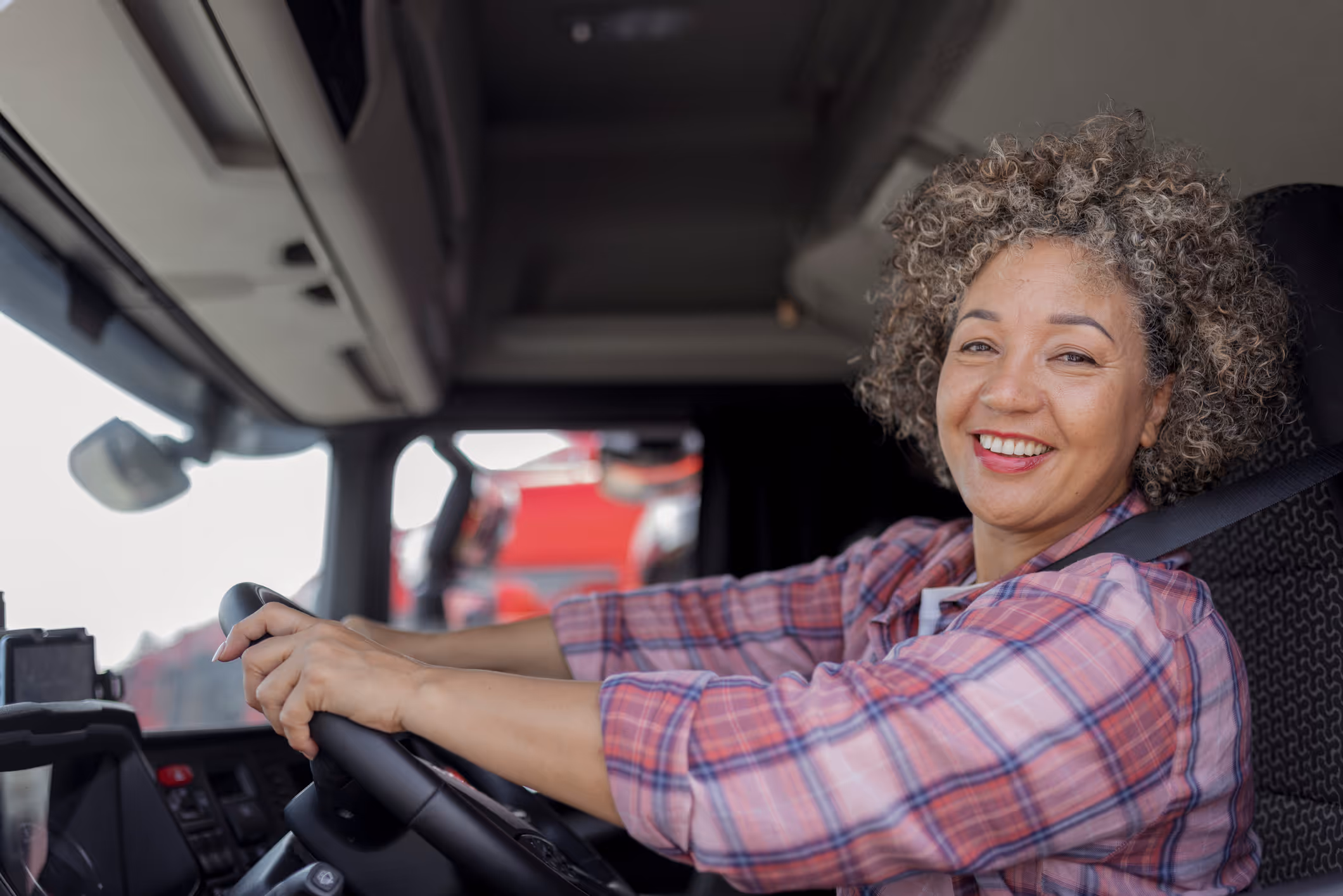 Female truck driver in cab