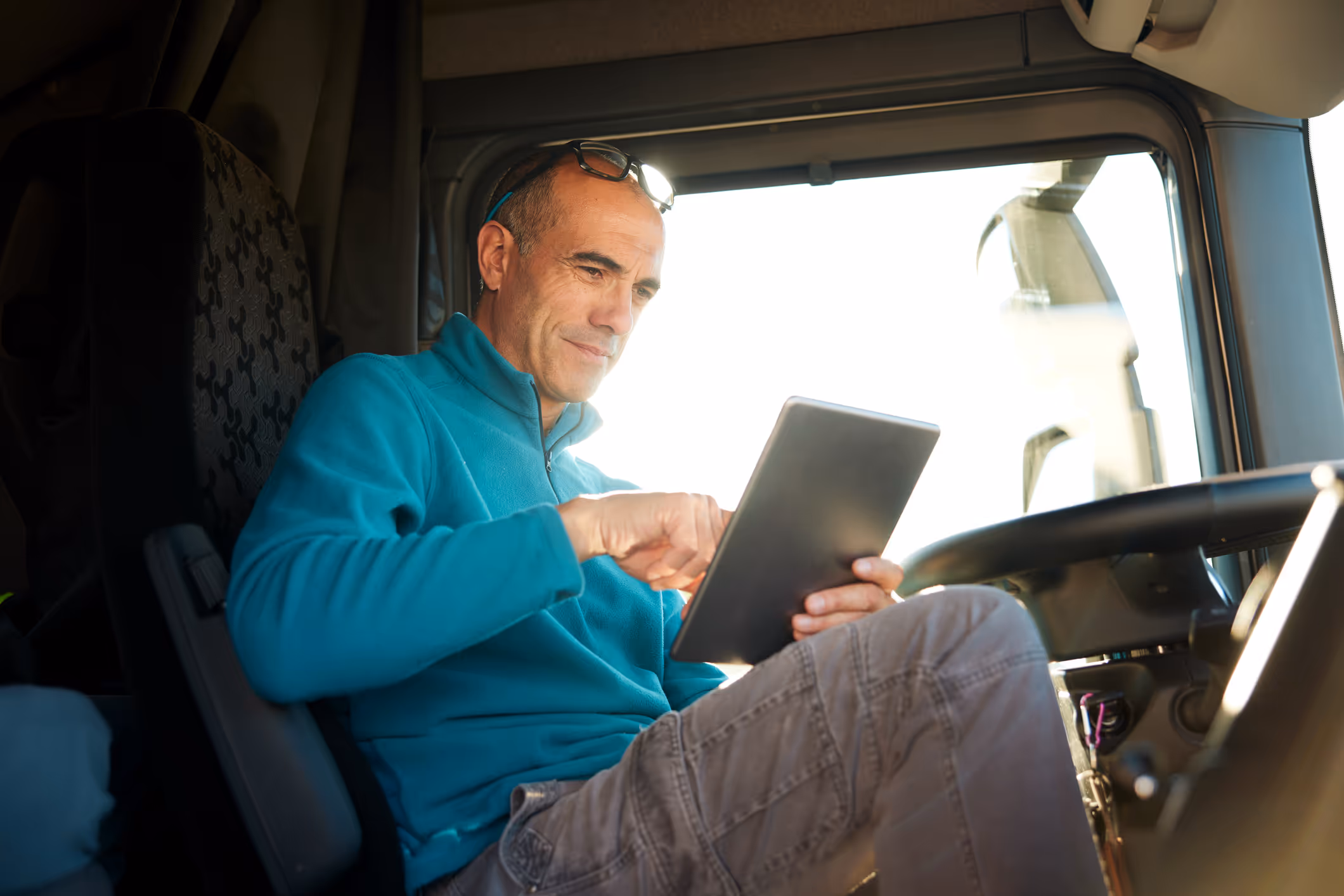 Truck driver using technology in cab