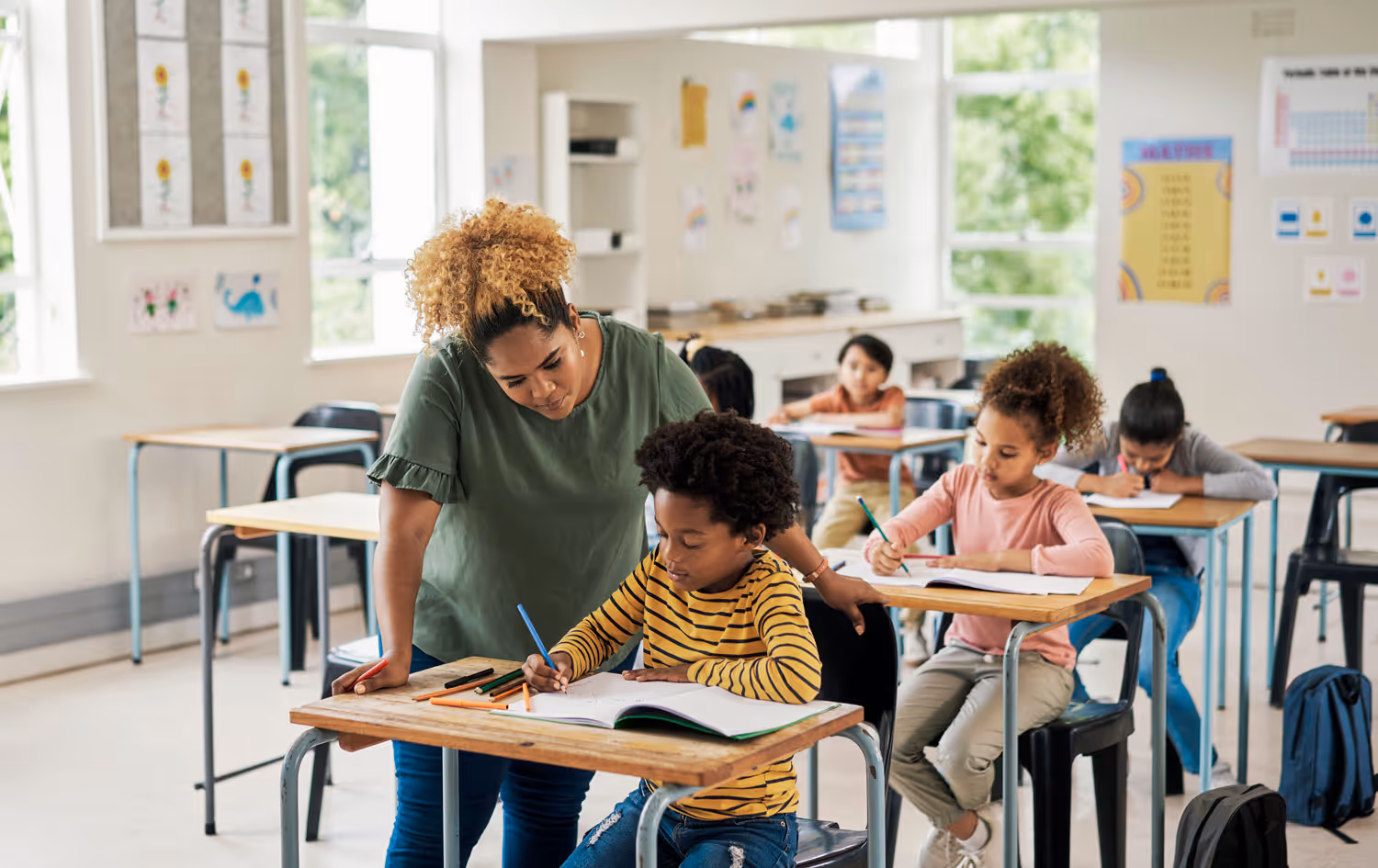 Teacher helping student in classroom