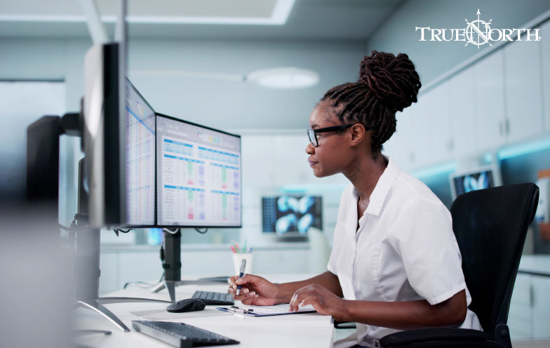 Woman completes work on her computer.