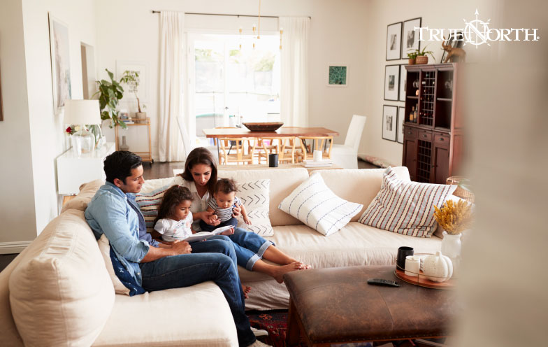A family reads together on a couch