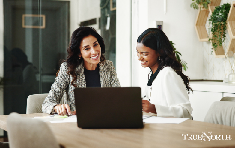 Two women collaborating in front of a computer