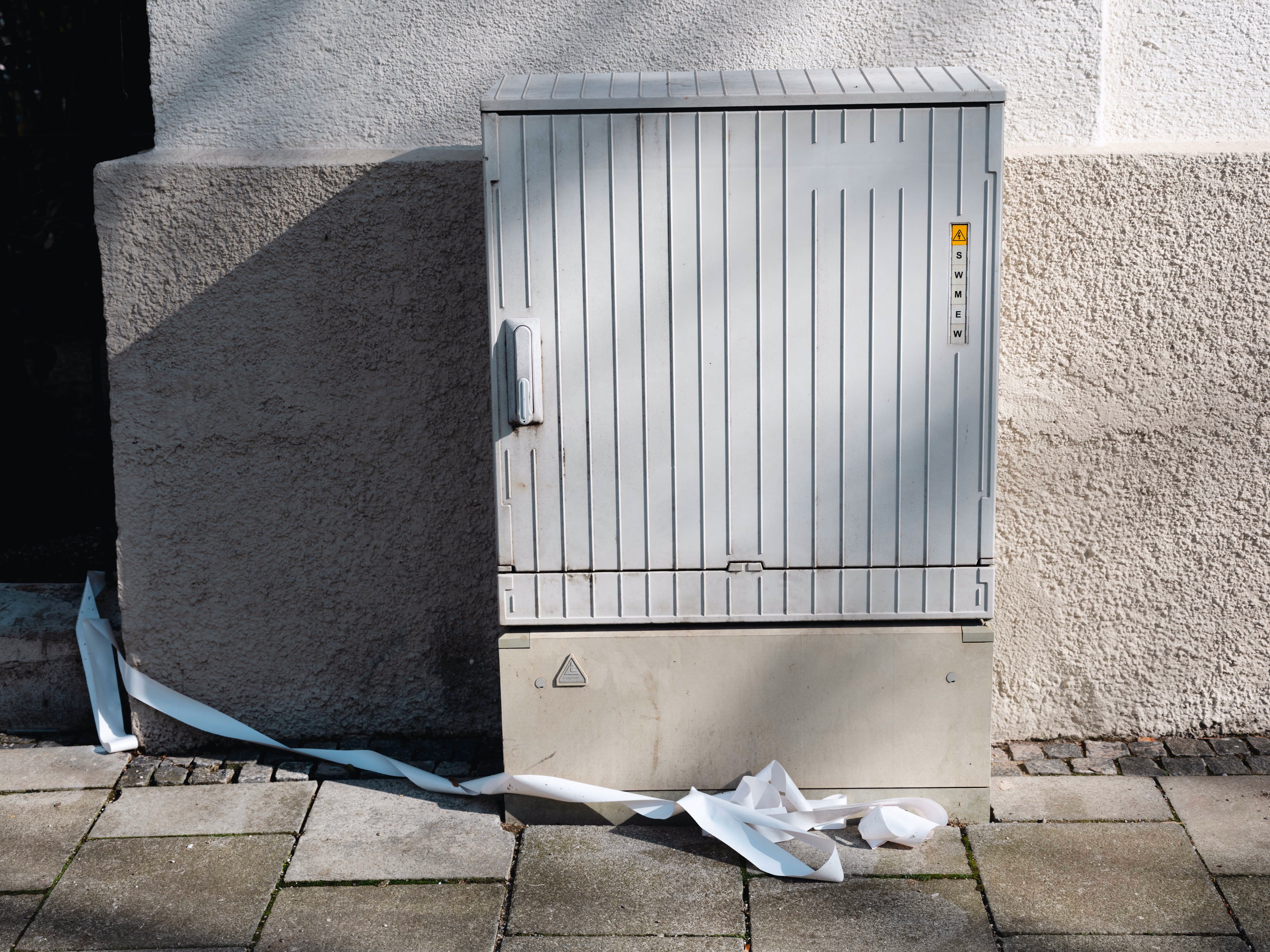 a metal box next to a wall