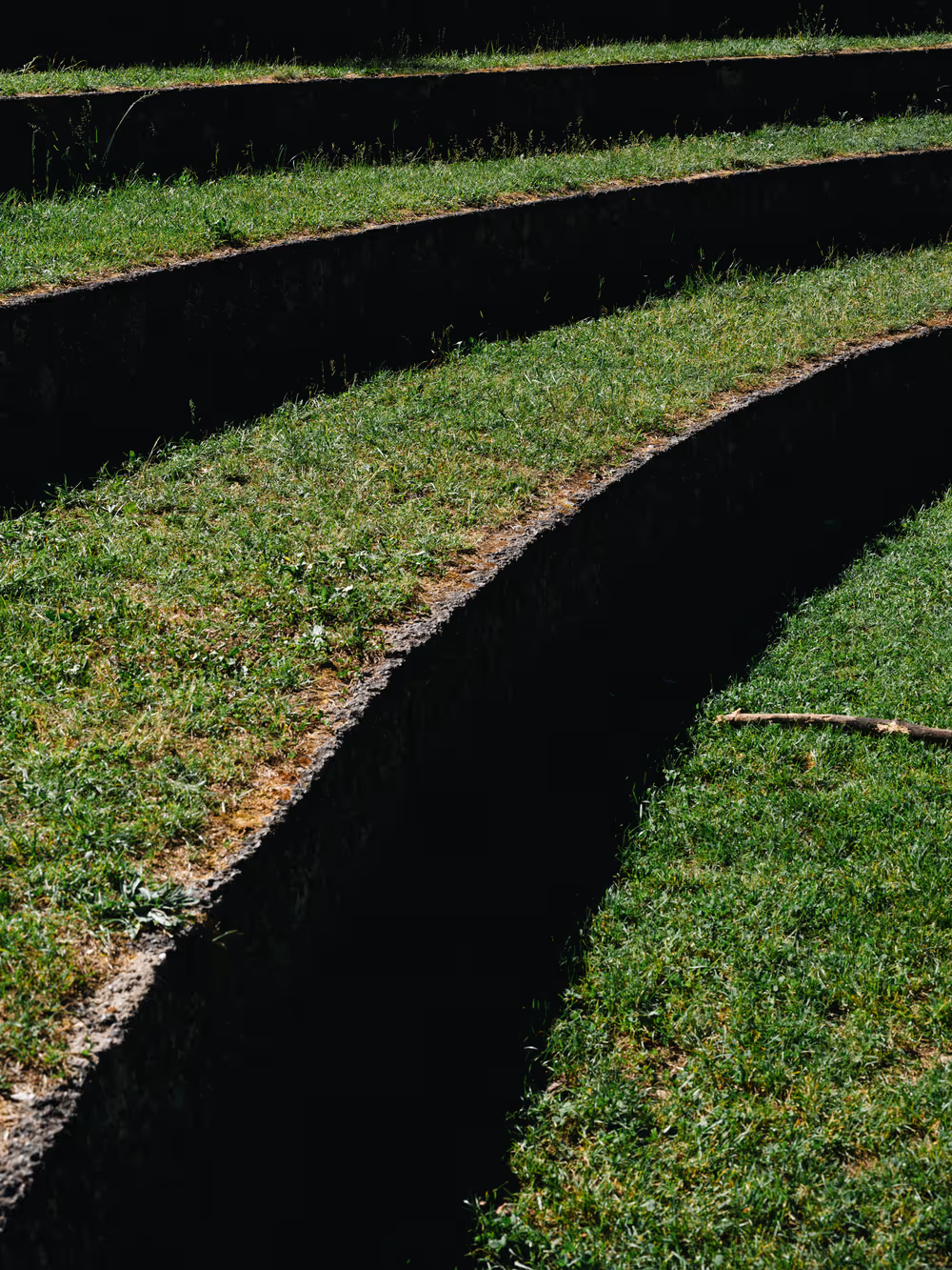 a grass field with a curved section