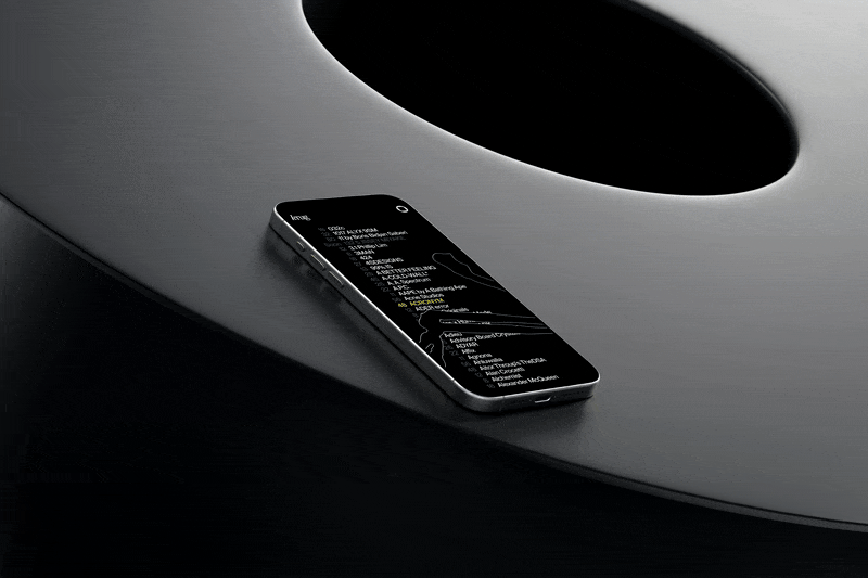 A black iPhone resting on a circular surface, showcasing its sleek design and modern aesthetics.