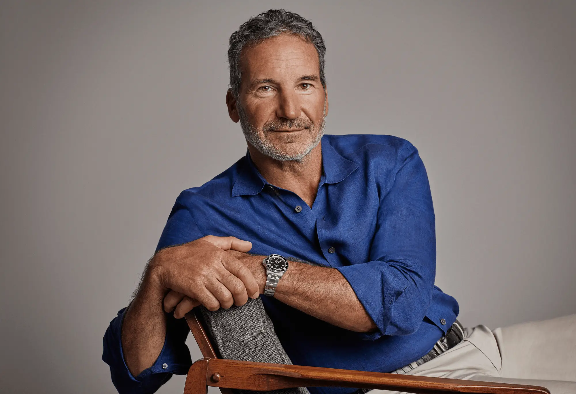 Portrait of legendary sailor Paul Cayard wearing a blue shirt and Rolex watch, reflecting his legacy in competitive sailing and his long-standing connection with the Maxi Yacht Rolex Cup.