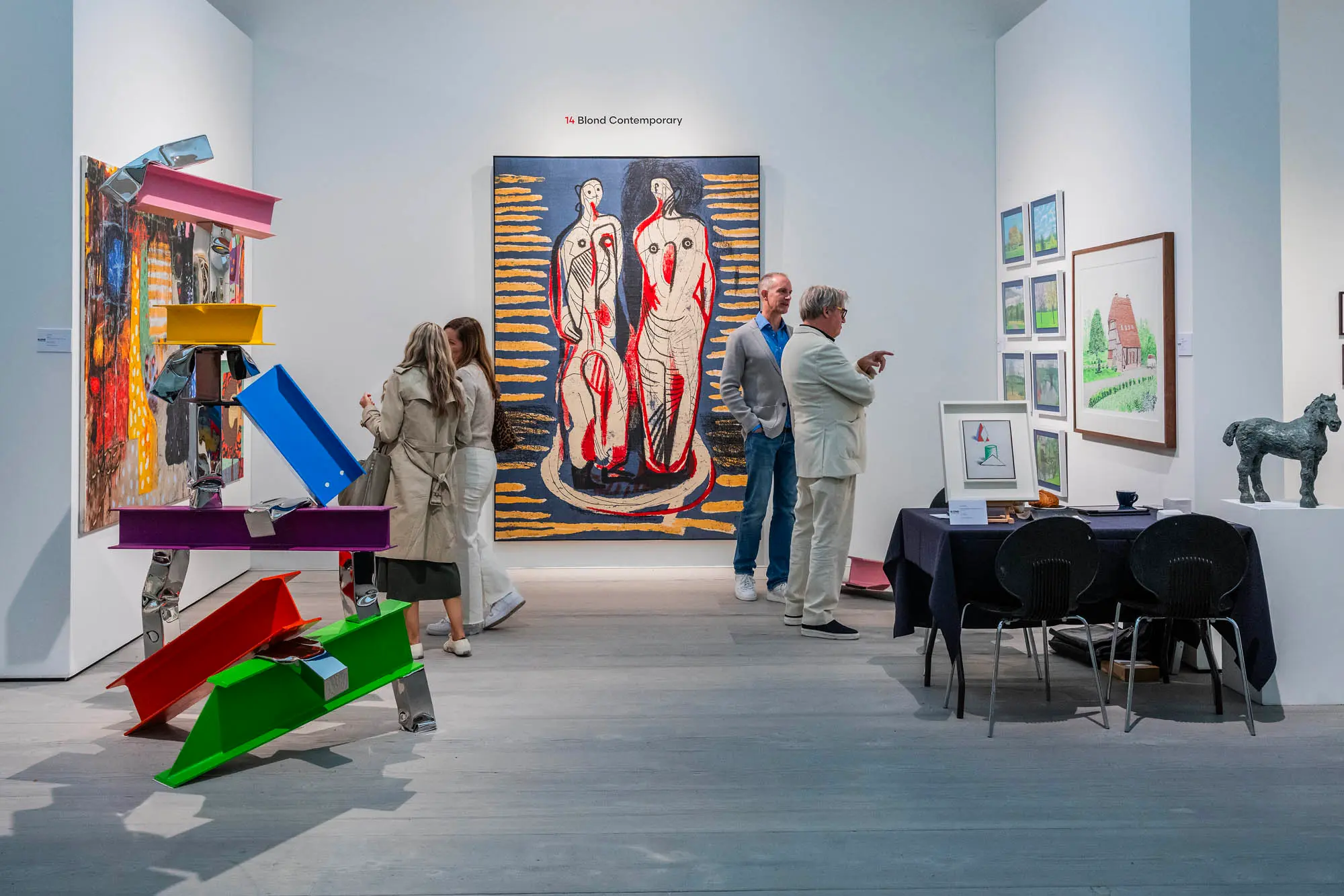 Art collectors and enthusiasts browse vibrant paintings and sculptures at the British Art Fair 2025 inside the Saatchi Gallery, highlighting a diverse mix of modern and contemporary British artworks.