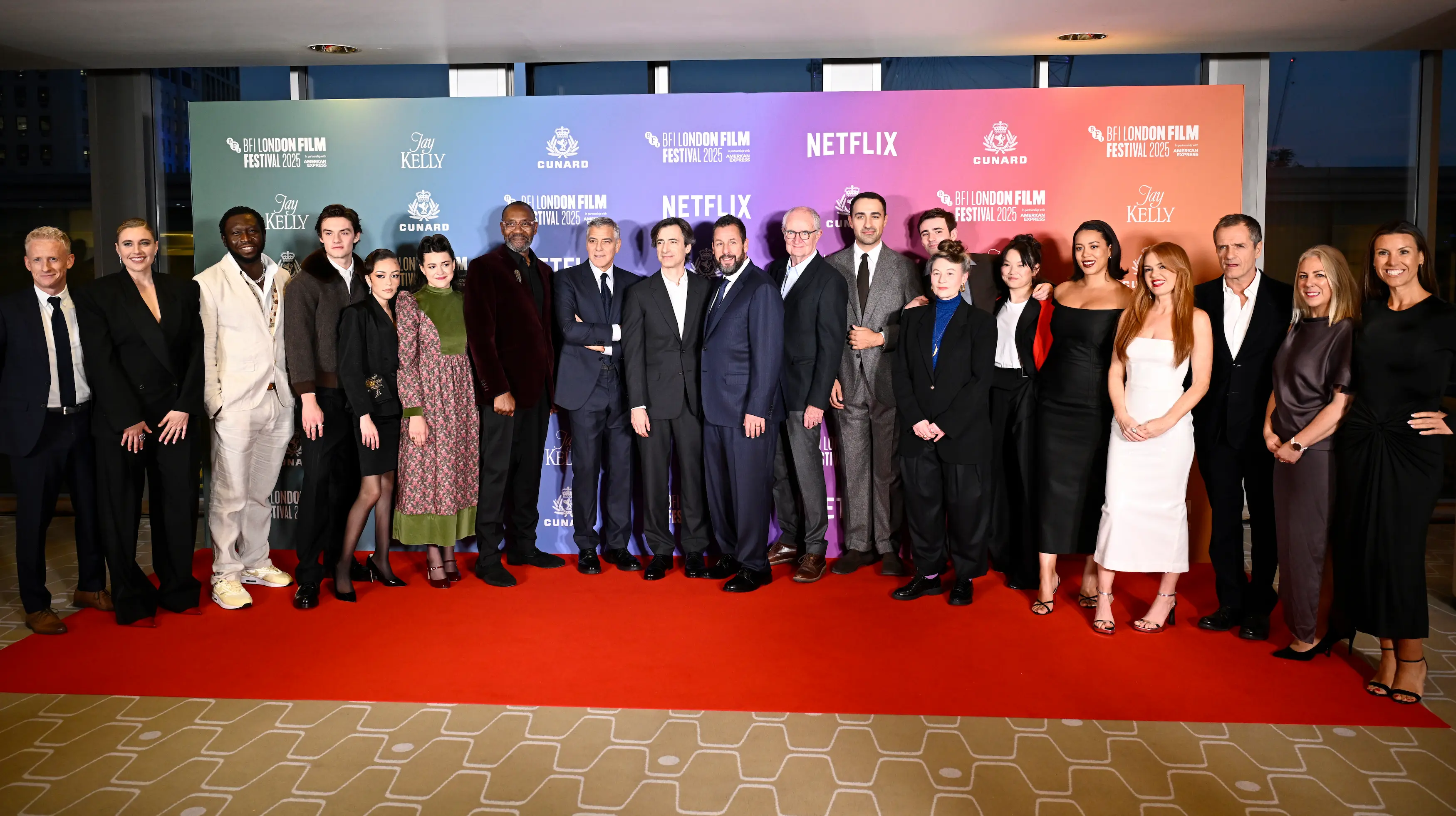 The cast and crew of Jay Kelly pose together on the red carpet during their premiere at the BFI London Film Festival 2025, presented in partnership with Netflix and Cunard.