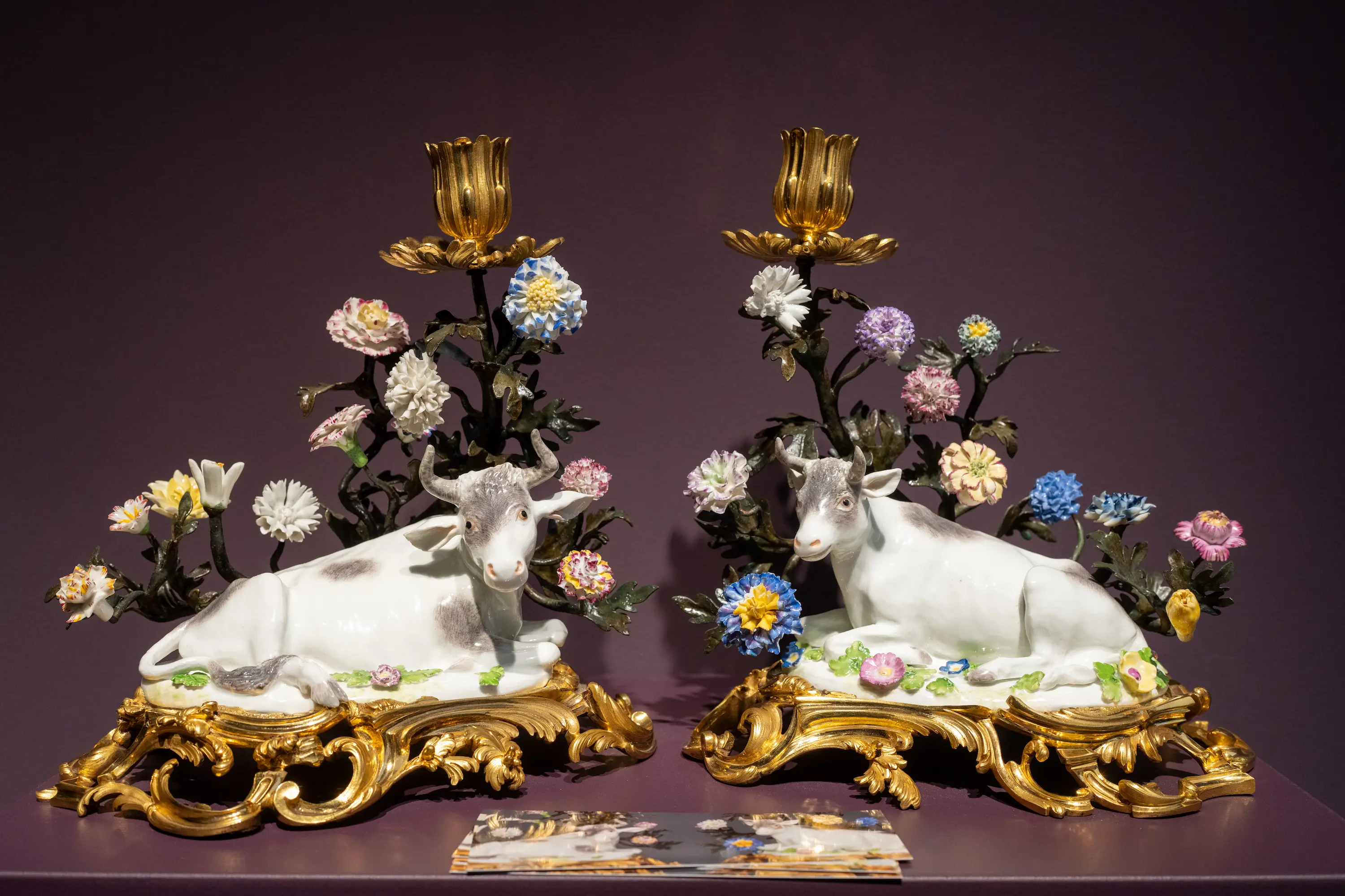 Close-up of intricately painted porcelain figures with gilded bases at Frieze Masters 2025.