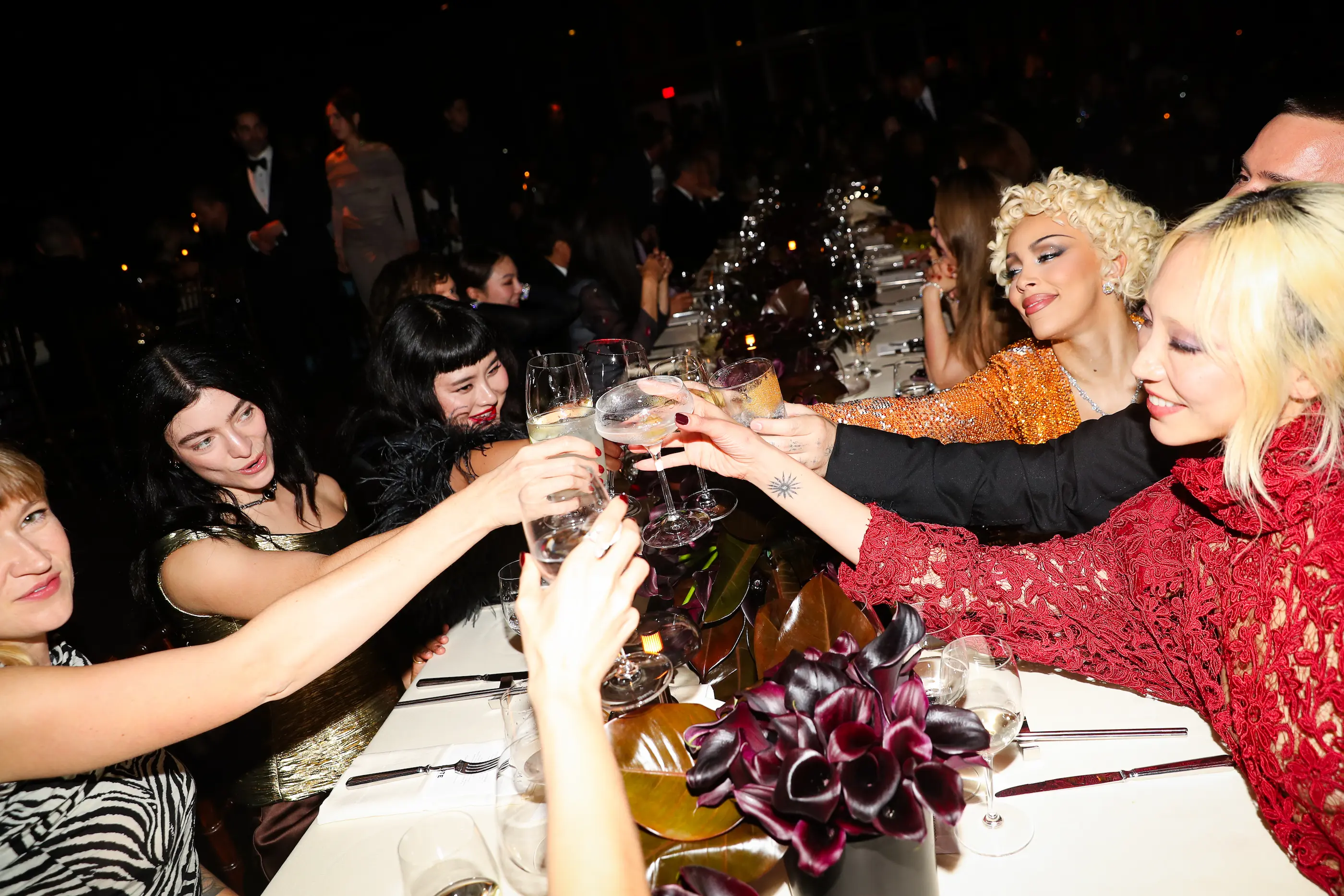 Two elegant cocktail glasses with olives beside a tennis ball on a sunlit table, evoking a luxurious summer tennis lifestyle.
