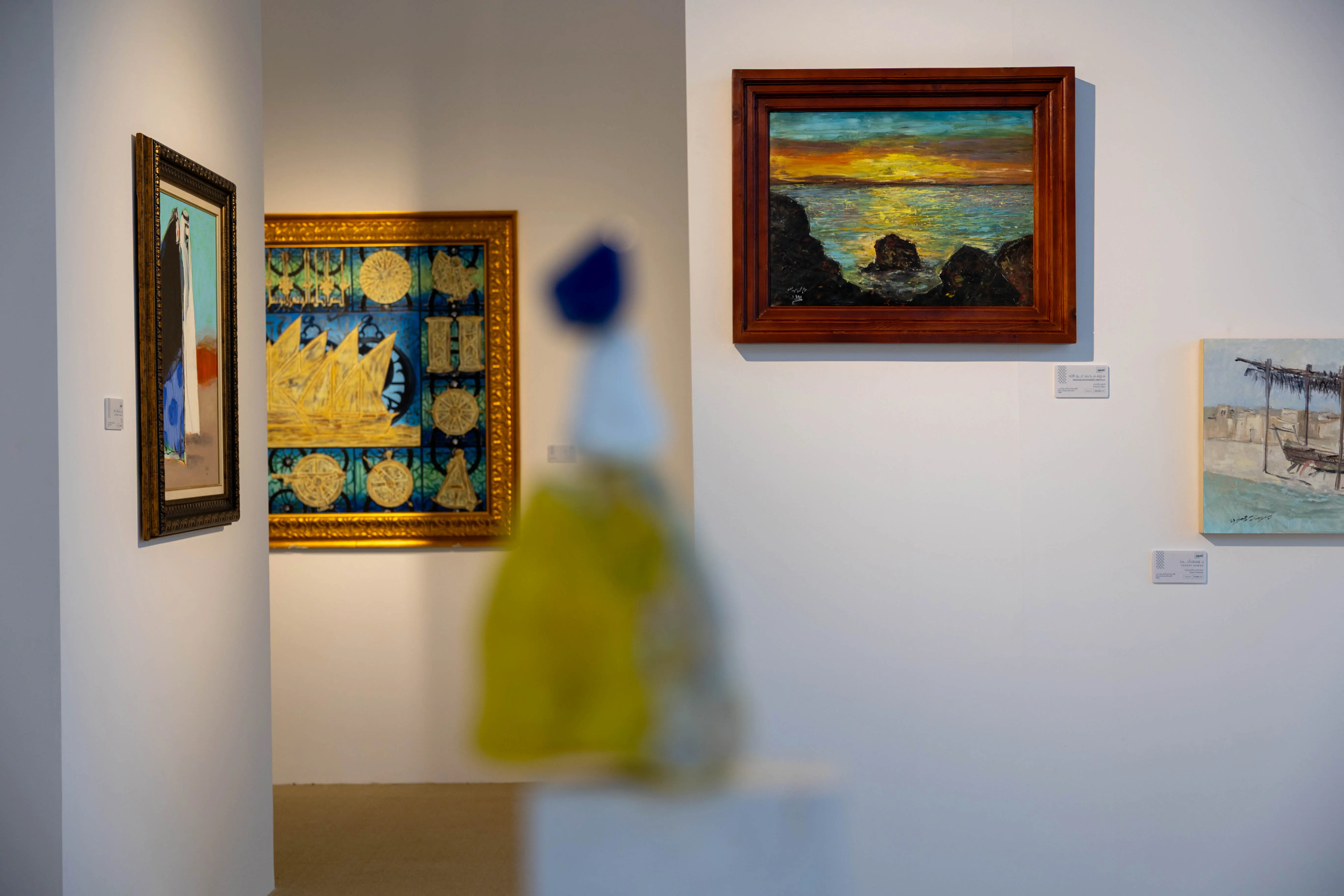 Interior view of the Oshar Art Gallery at the Qatar Boat Show 2025, featuring paintings by Qatari artists celebrating the nation’s maritime history and cultural legacy.
