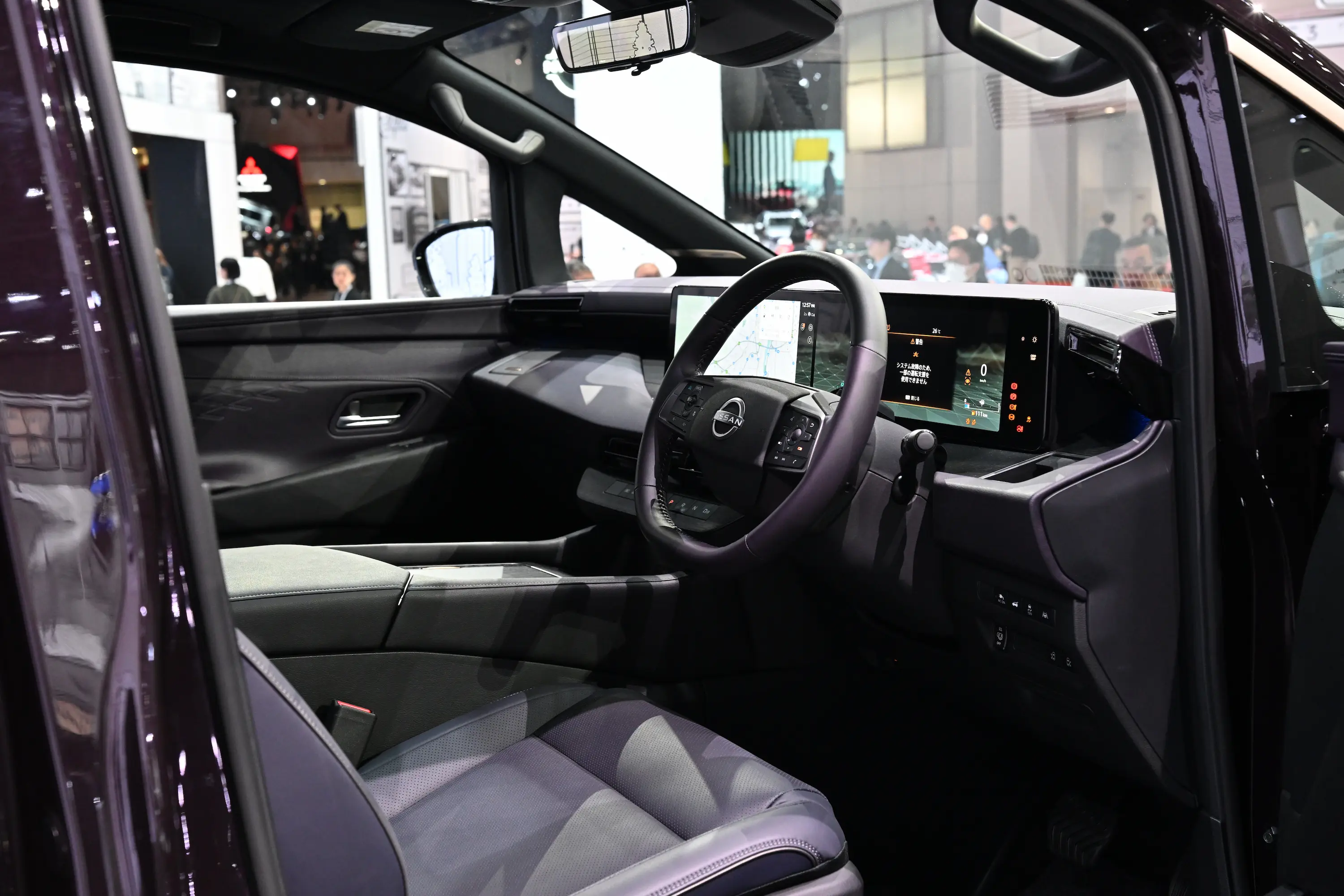 Close-up view of the luxurious and high-tech interior of the new Nissan Elgrand, featuring a modern dashboard, digital displays, and premium materials, unveiled at the Japan Mobility Show 2025 in Tokyo.