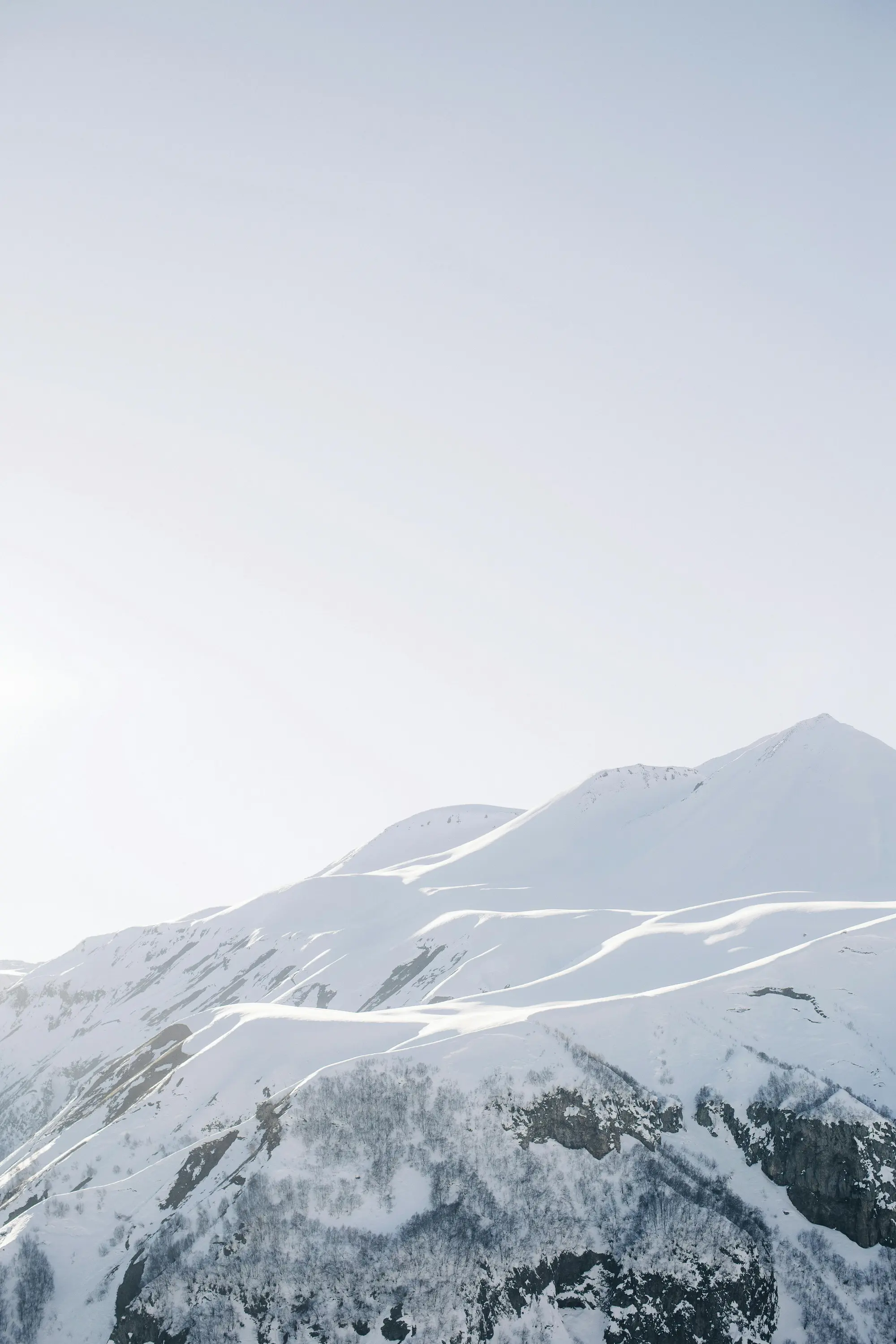 Pristine snow-covered Swiss alpine mountain peaks under soft winter sky