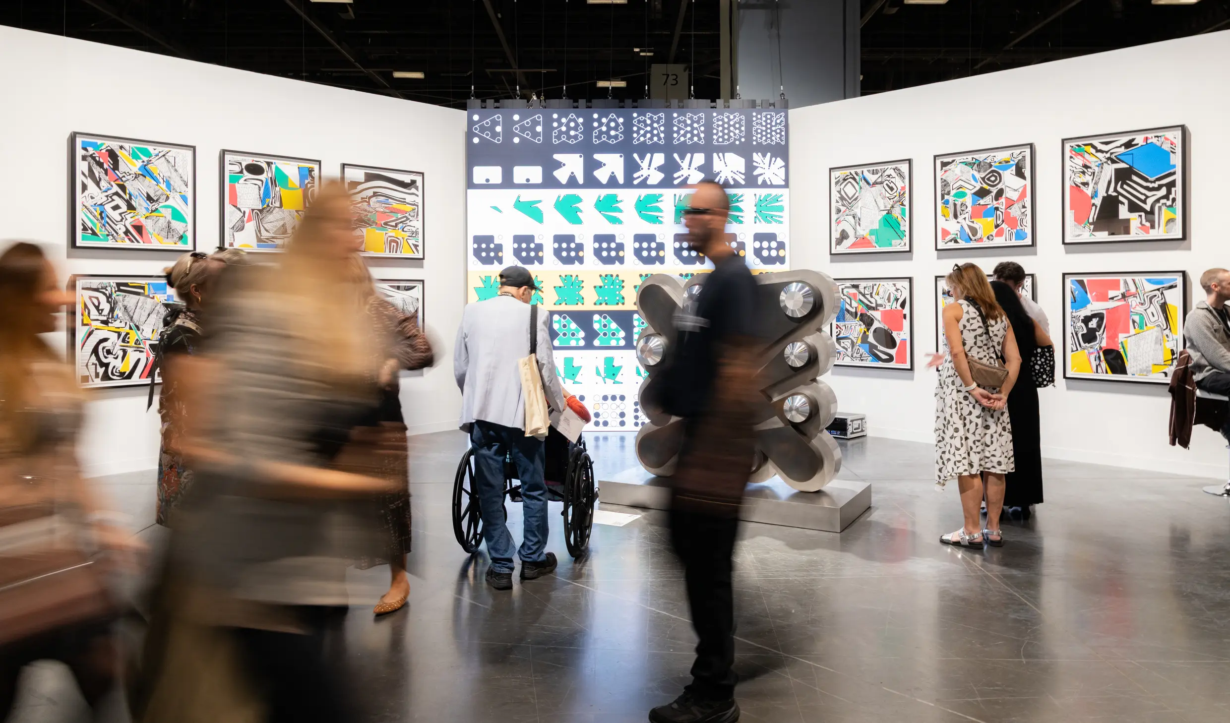 Art Basel Miami Beach 2025 Zero 10 digital art section featuring metallic bear sculpture, generative art prints on walls, and visitors exploring inaugural digital art exhibition