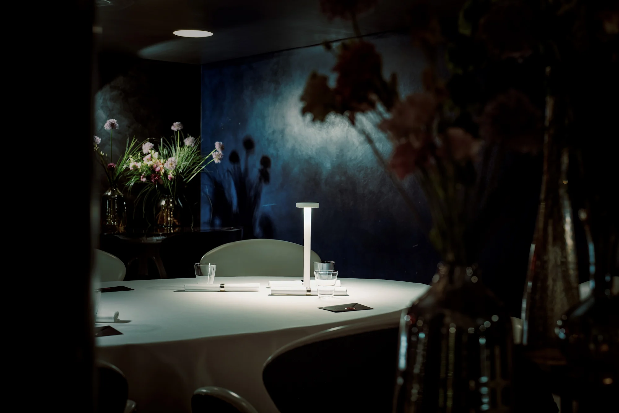 Intimate fine dining table at 7132 Hotel Silver restaurant with contemporary art backdrop and minimalist design in Vals Switzerland