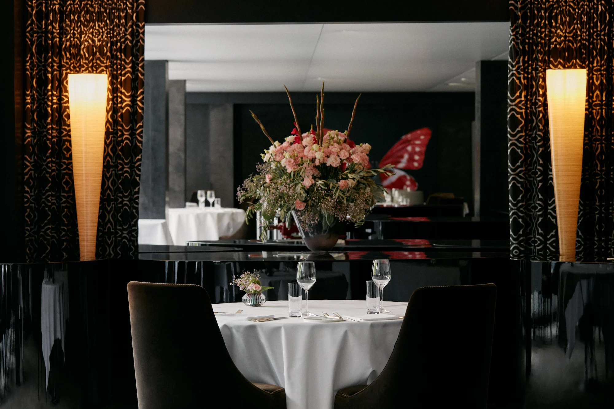 Elegant table setting at 7132 Hotel Red restaurant featuring ornate wall panels and ambient lighting in Vals luxury resort