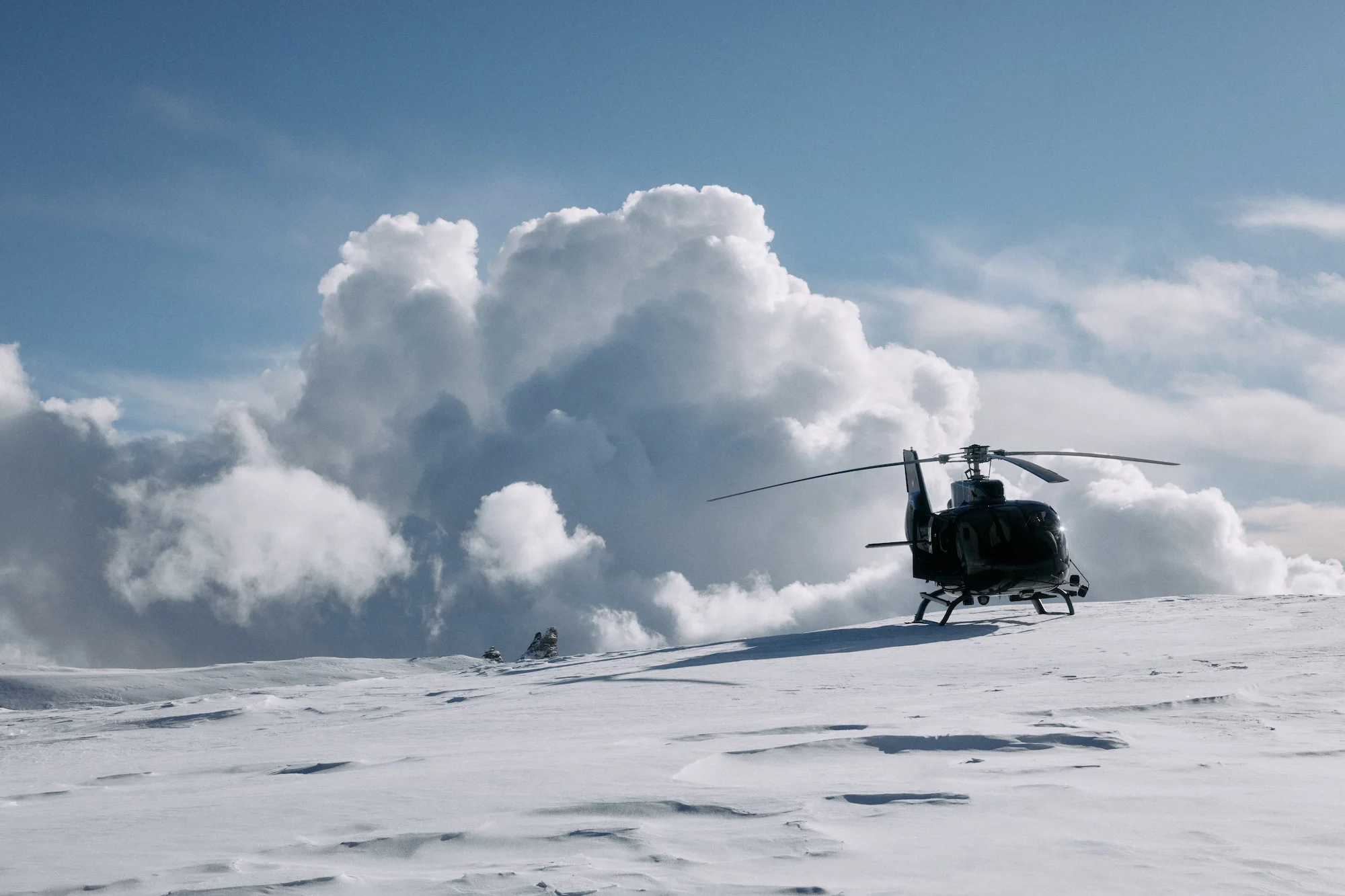 Private helicopter transfer service on snow-covered alpine peak at 7132 Hotel luxury resort in Vals Switzerland