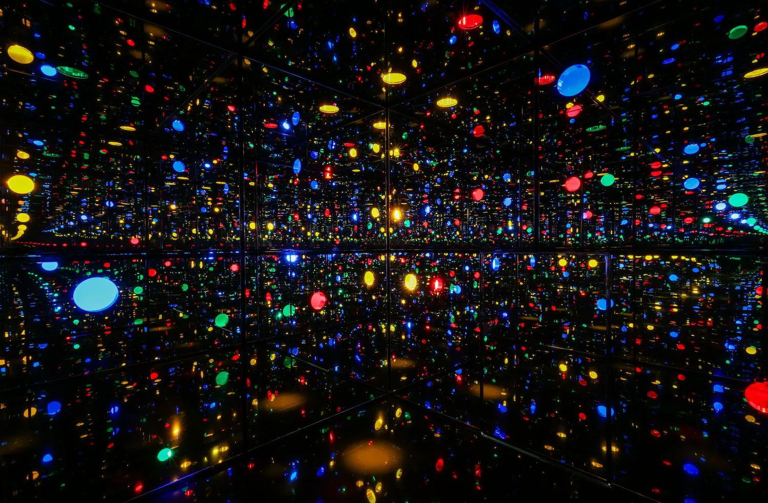 Yayoi Kusama's Infinity Mirrored Room Illusion Inside the Heart with colorful LED lights reflecting infinitely at Fondation Beyeler retrospective 2025