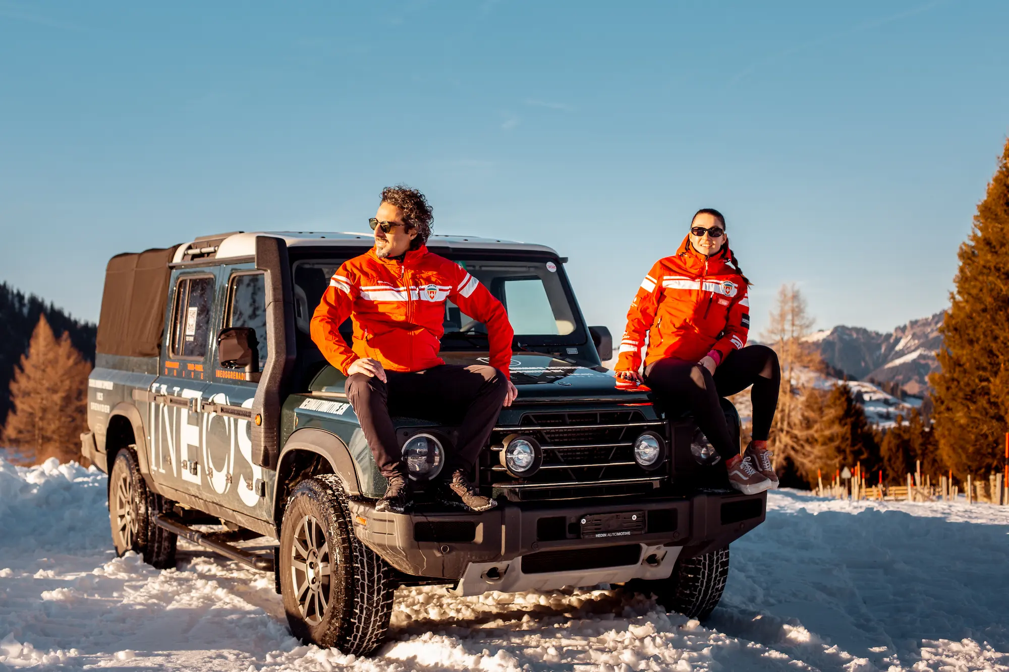 Ski School Rougemont instructors with branded INEOS vehicle in authentic Pays d'Enhaut valley showcasing bespoke ski instruction service in traditional Swiss mountain village