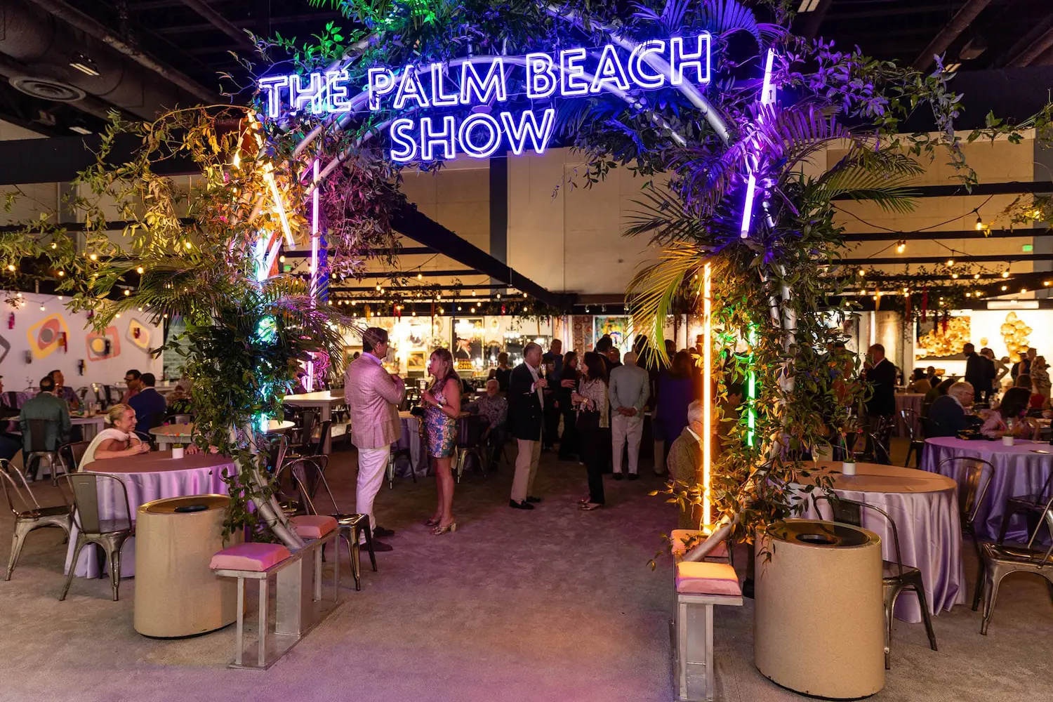 Sophisticated VIP lounge and cocktail reception area at The Palm Beach Show 2026 opening night gala featuring dramatic neon signage, tropical botanical installations.