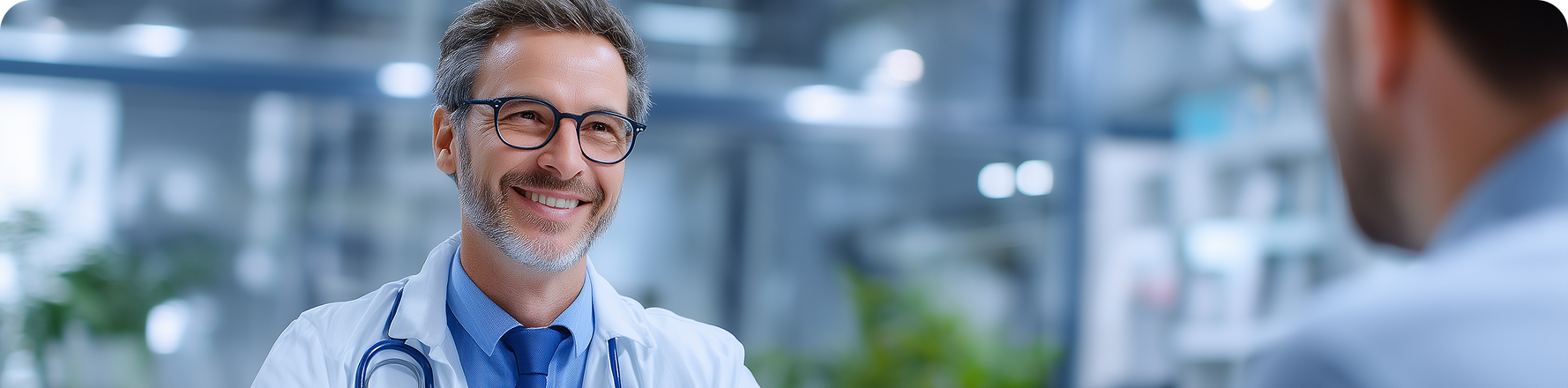 Older man smiling outdoors with friends, surrounded by greenery.