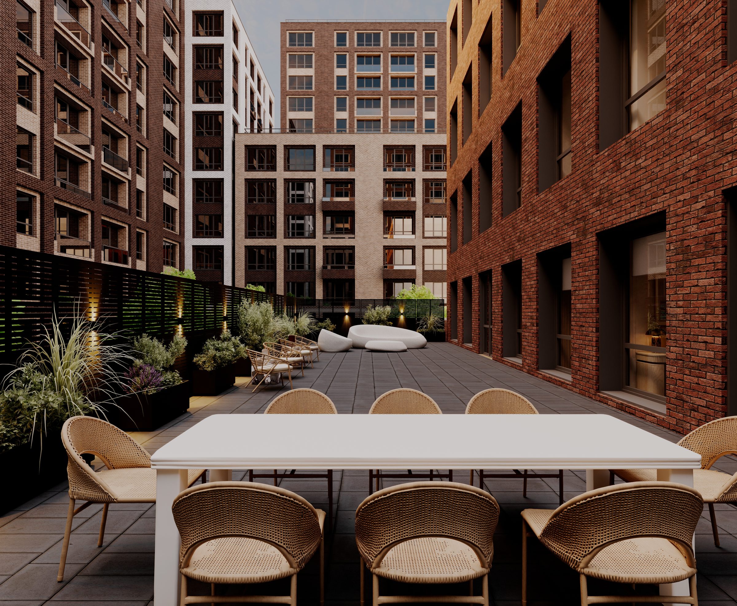 The PrimaryMD SoHo terrace, with a long table and planted borders