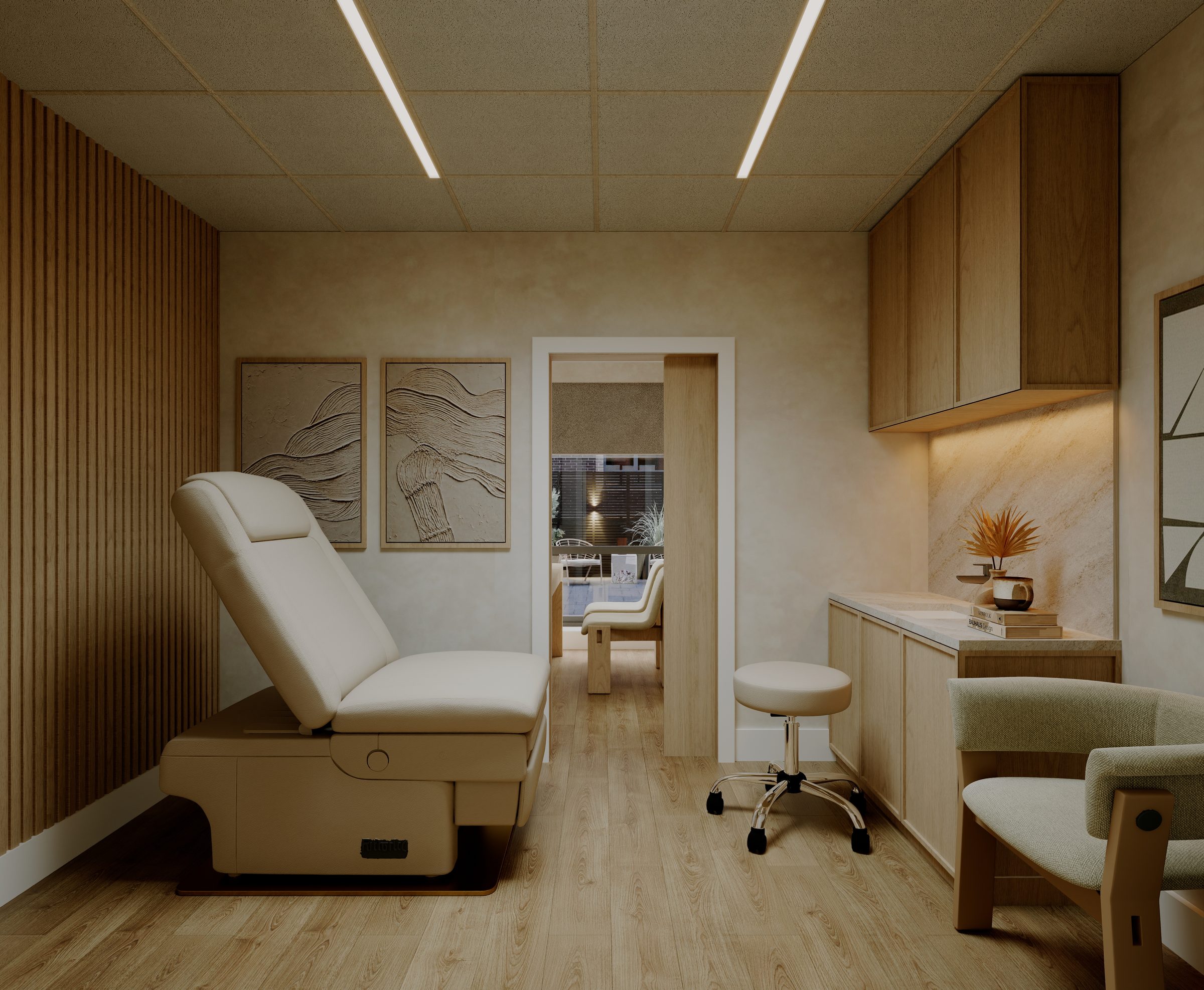 A PrimaryMD SoHo exam room, with an exam table and wood cabinetry
