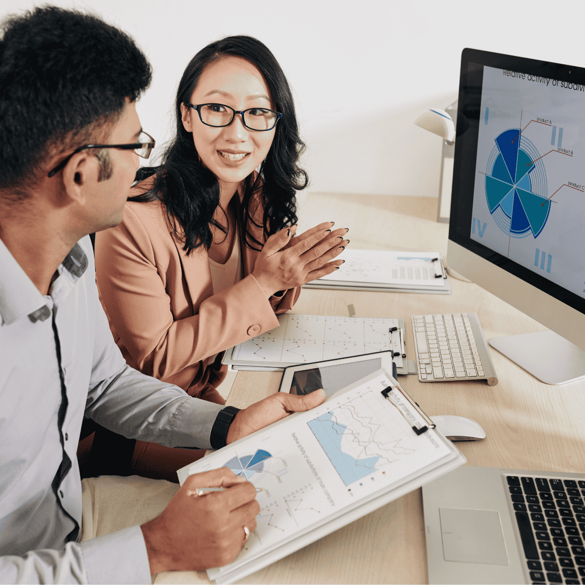 People looking at analytics and reports on a screen 