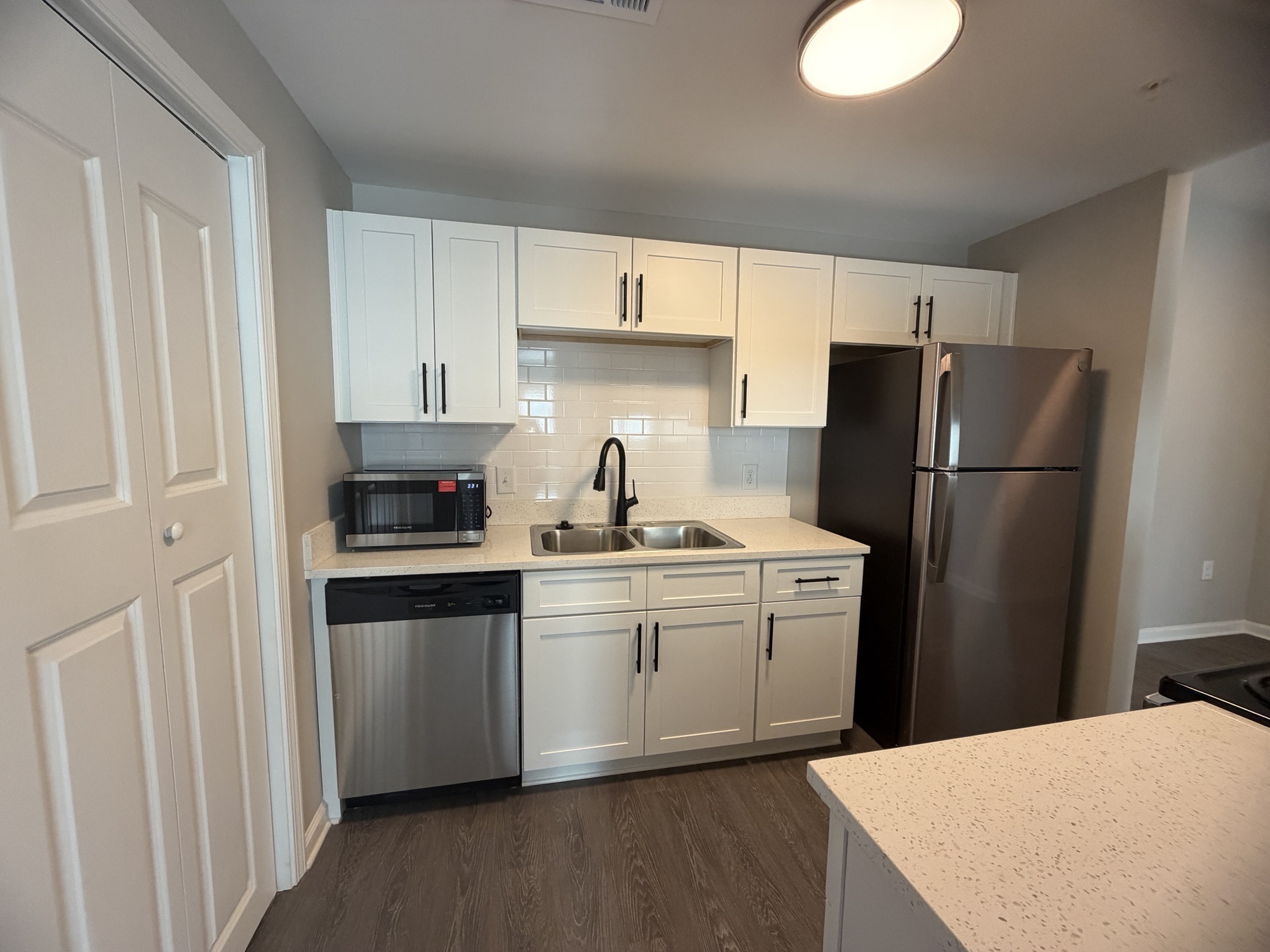 Kitchen with white cabinets and stainless steel appliances