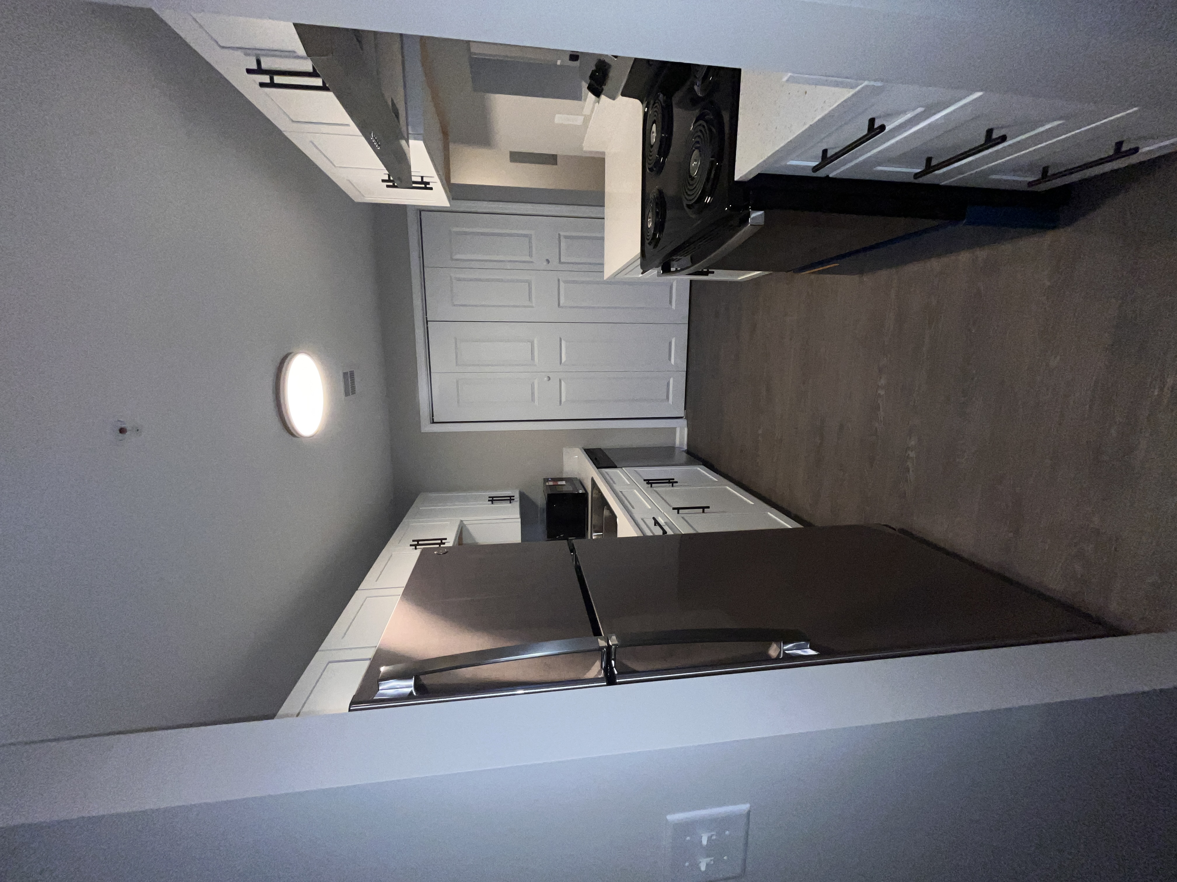 Kitchen with white cabinets and stainless steel appliances