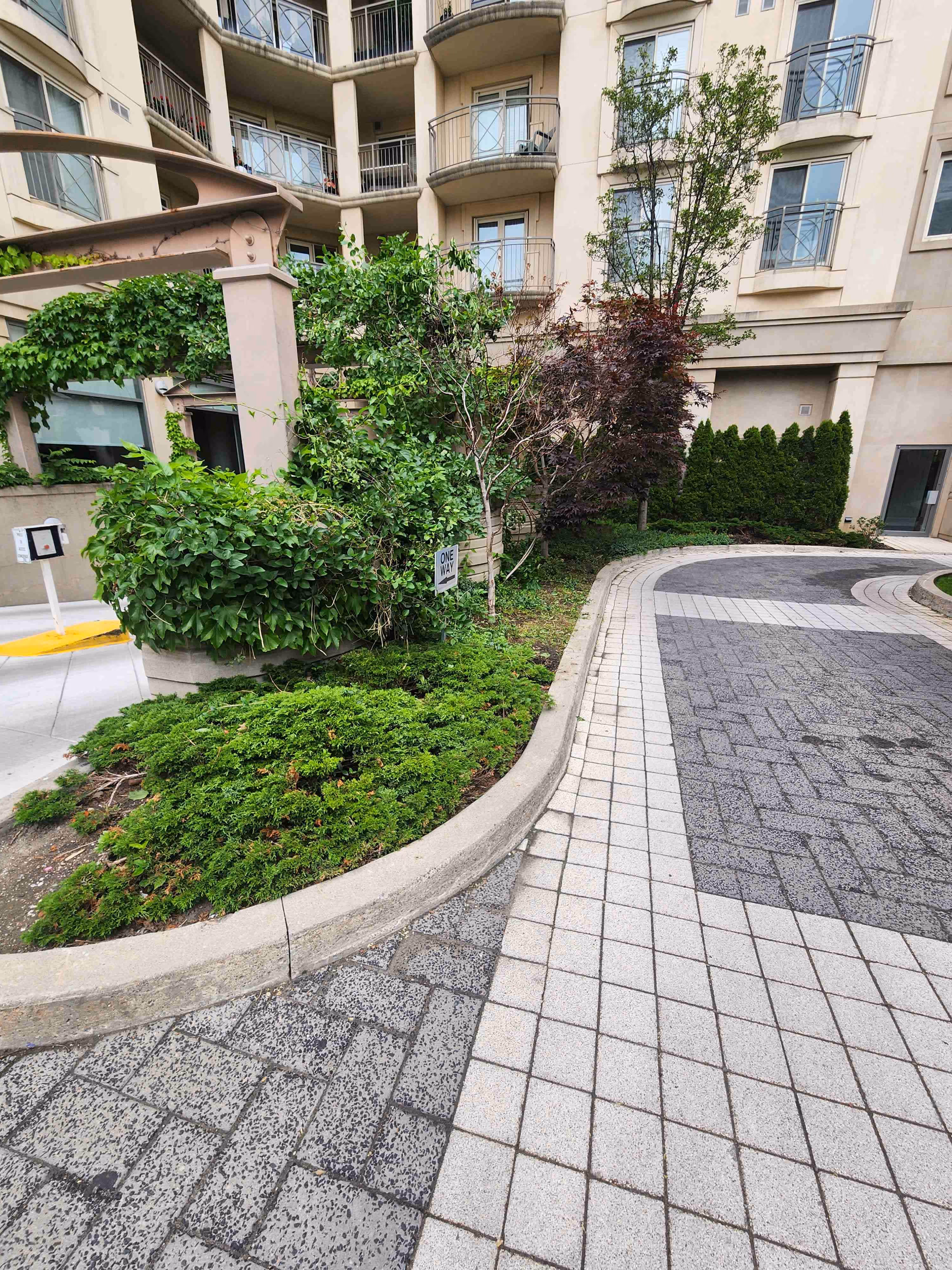 Gardens providing a visual cover for garage entrance. Keeping the peacful contemporary outdoor look without letting the entranceway impact the property feel.