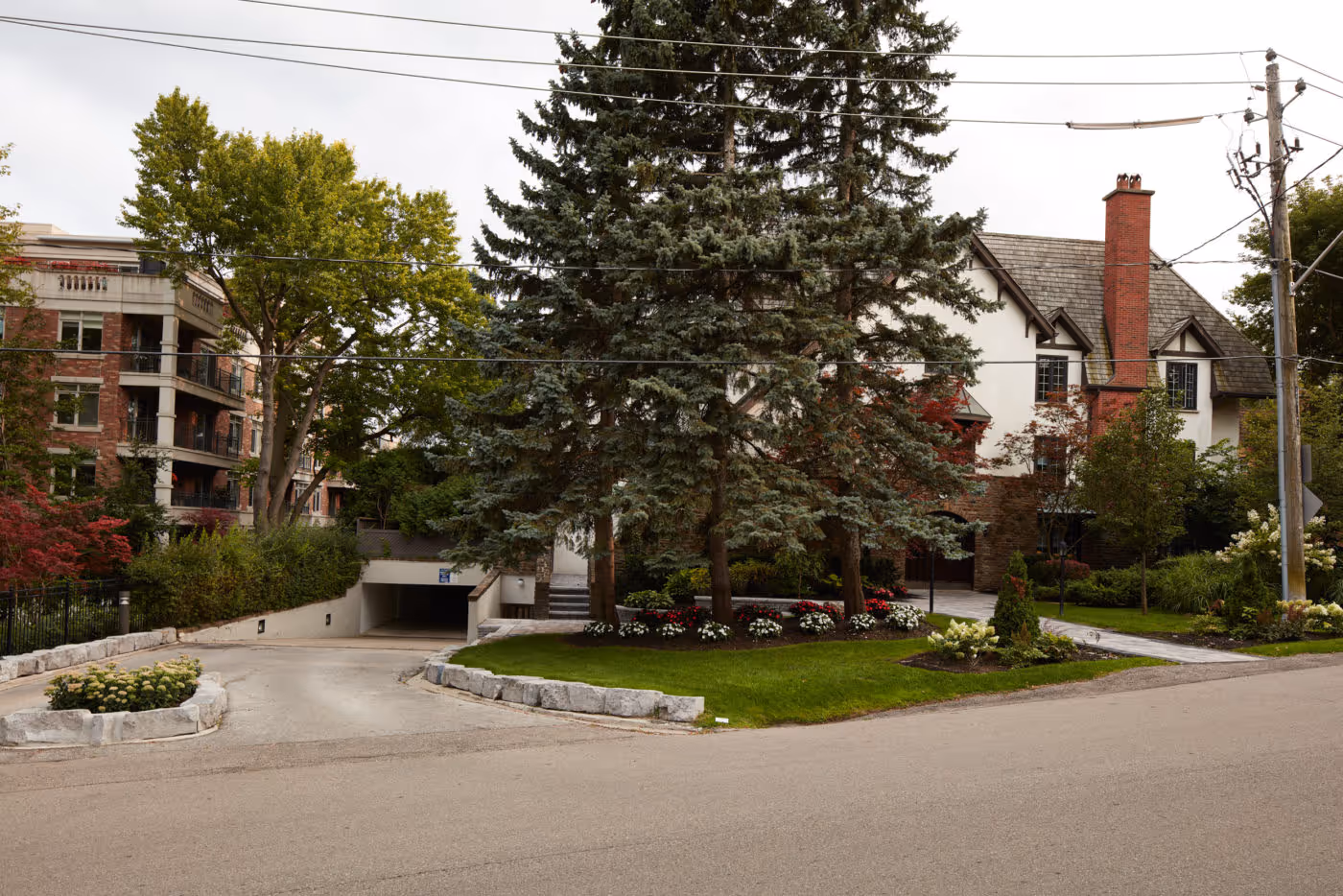 Traditional Landscape design and stonework creates welcoming entryway into underground parking space while seamlessesly blending in with surrounding nature