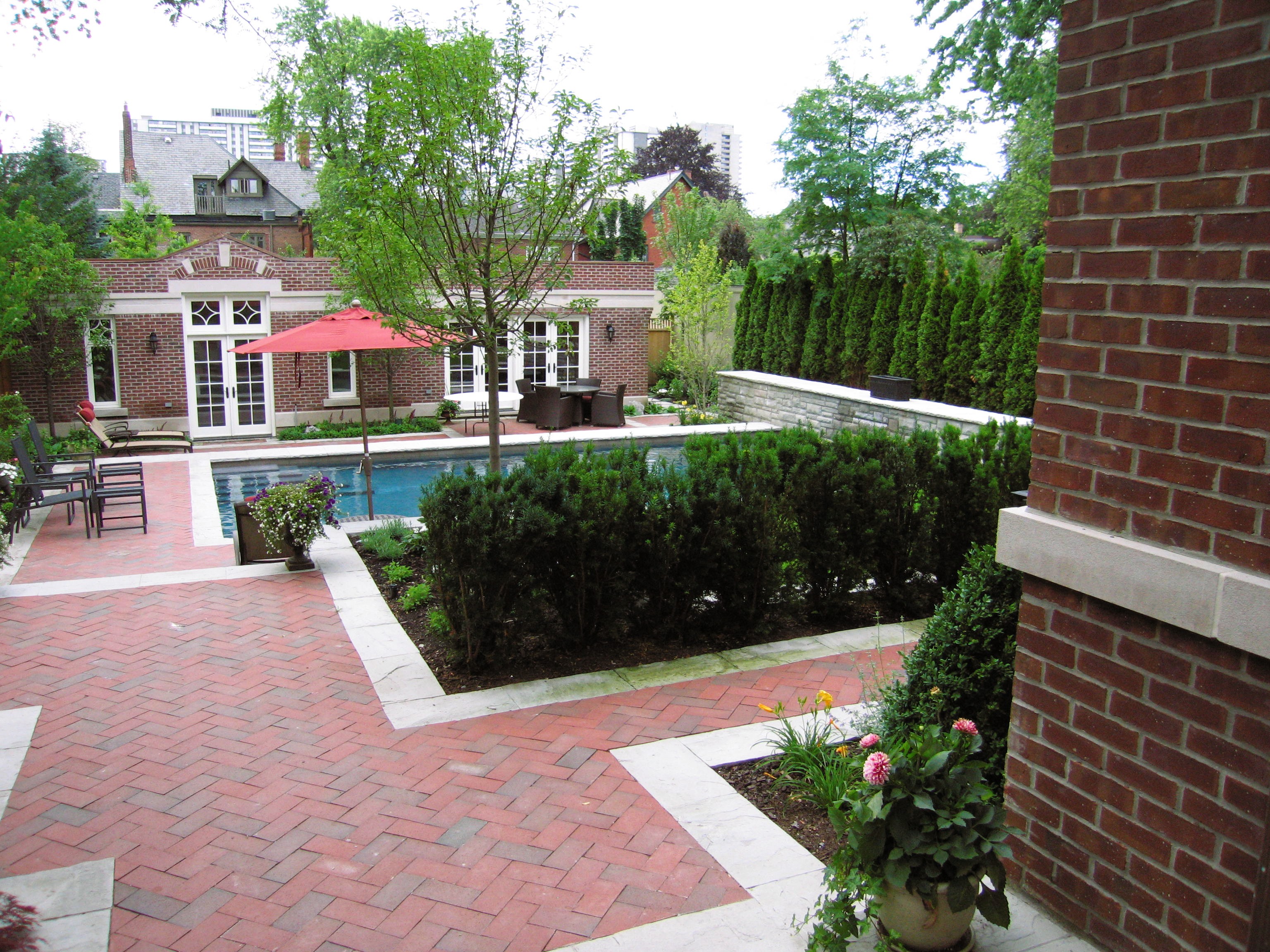 Backdoor Angle showing off Yew Hedge, Brick Stonework and Urn