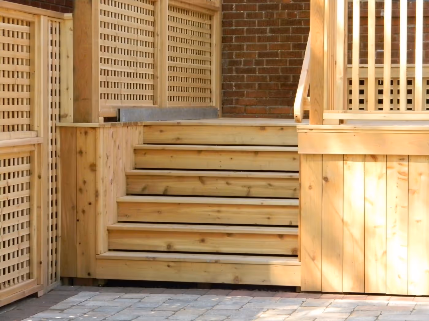 custom built wood deck with stairs and lattice built into the side for plant growth