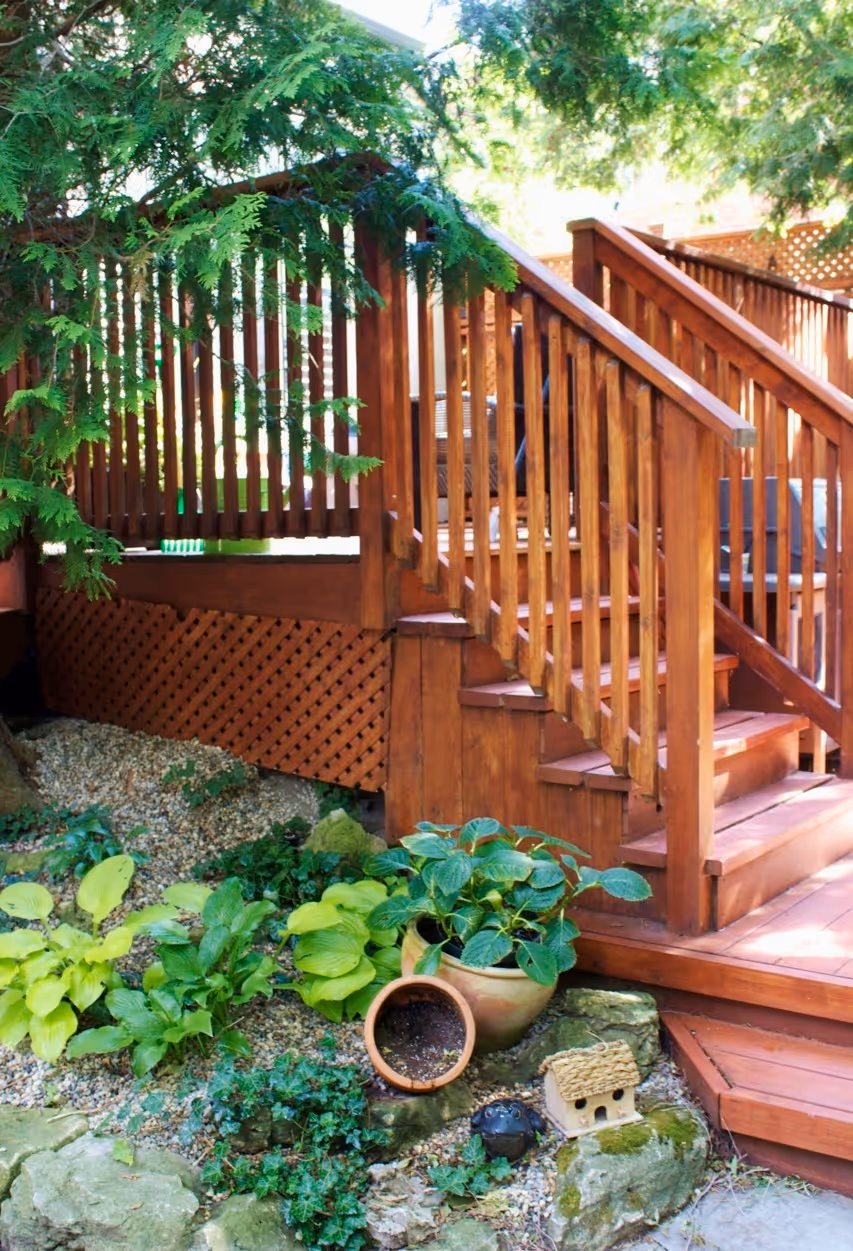 wood steps with natural stone pea gravel garden containing perrenials
