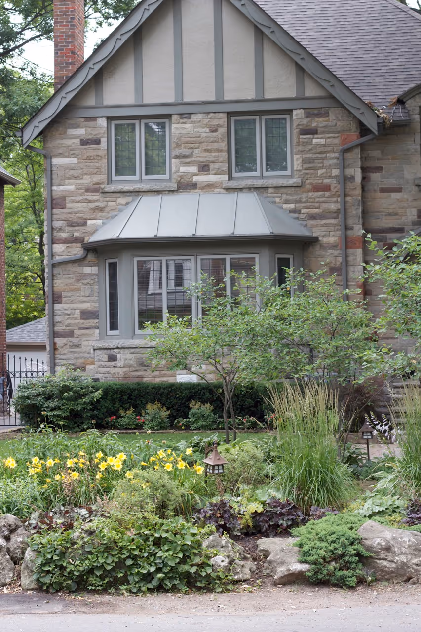 Front angle of the house showcasing natural gardens