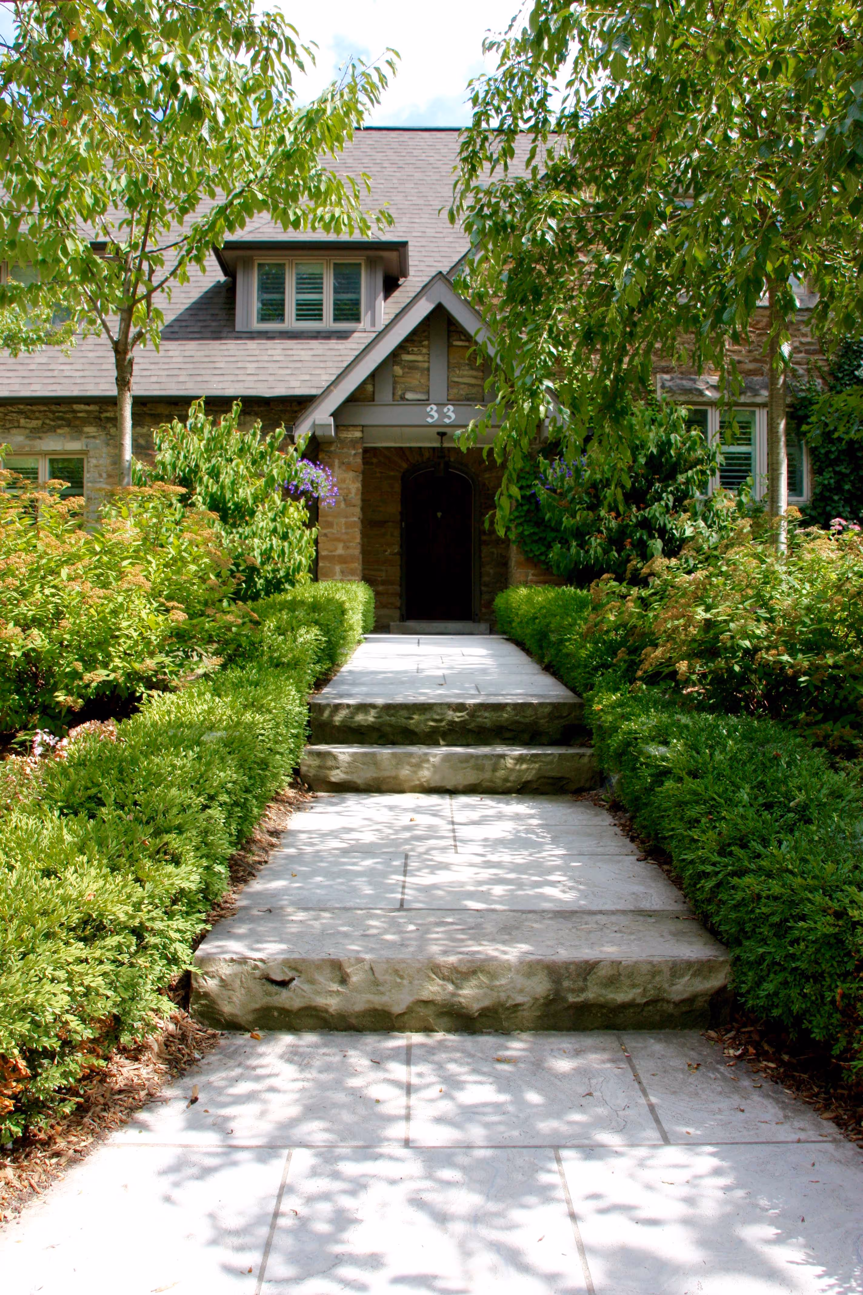 stone walkway with three levels towards front door