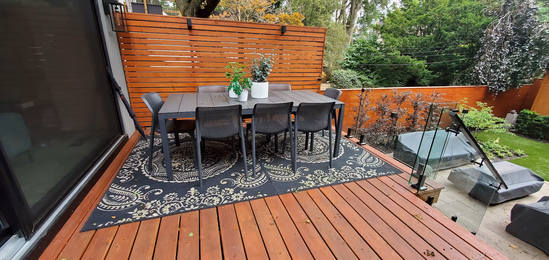 Upper deck seating area with dining area and back fence