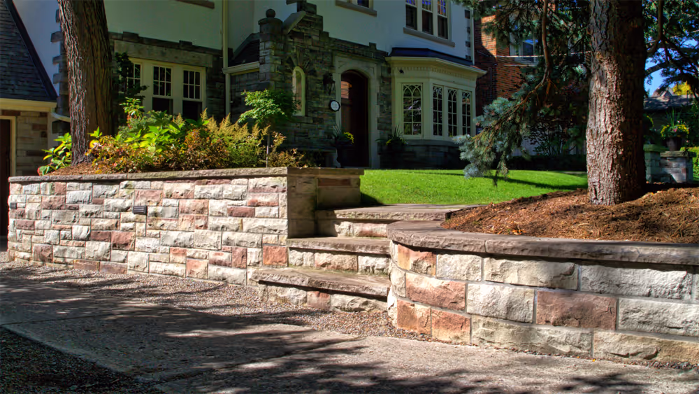 Traditional Stone wall separating front walk and driveway